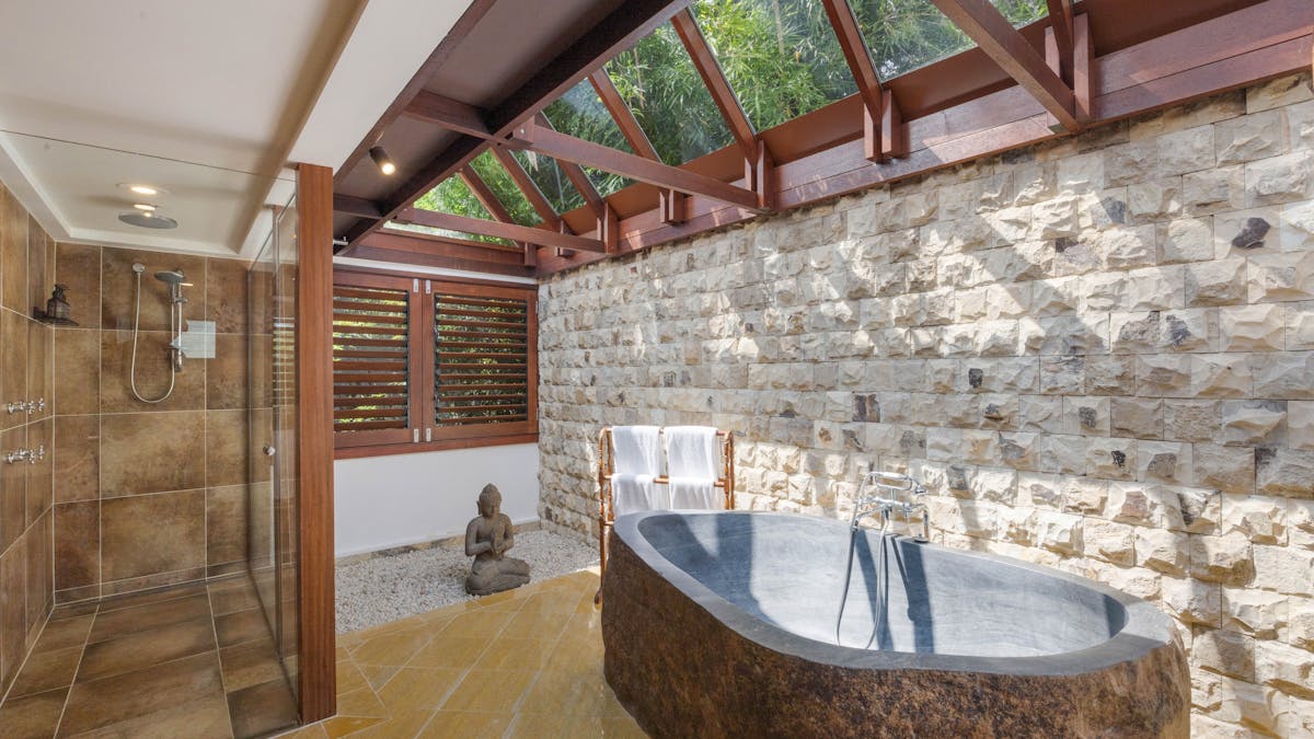 Hand carved, volcanic stone bathtub, under a clear roof Hand carved, volcanic stone bathtub, under a clear roof