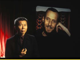 William Yang projects a slide of his friend Allan, whose story forms part of William's monologue