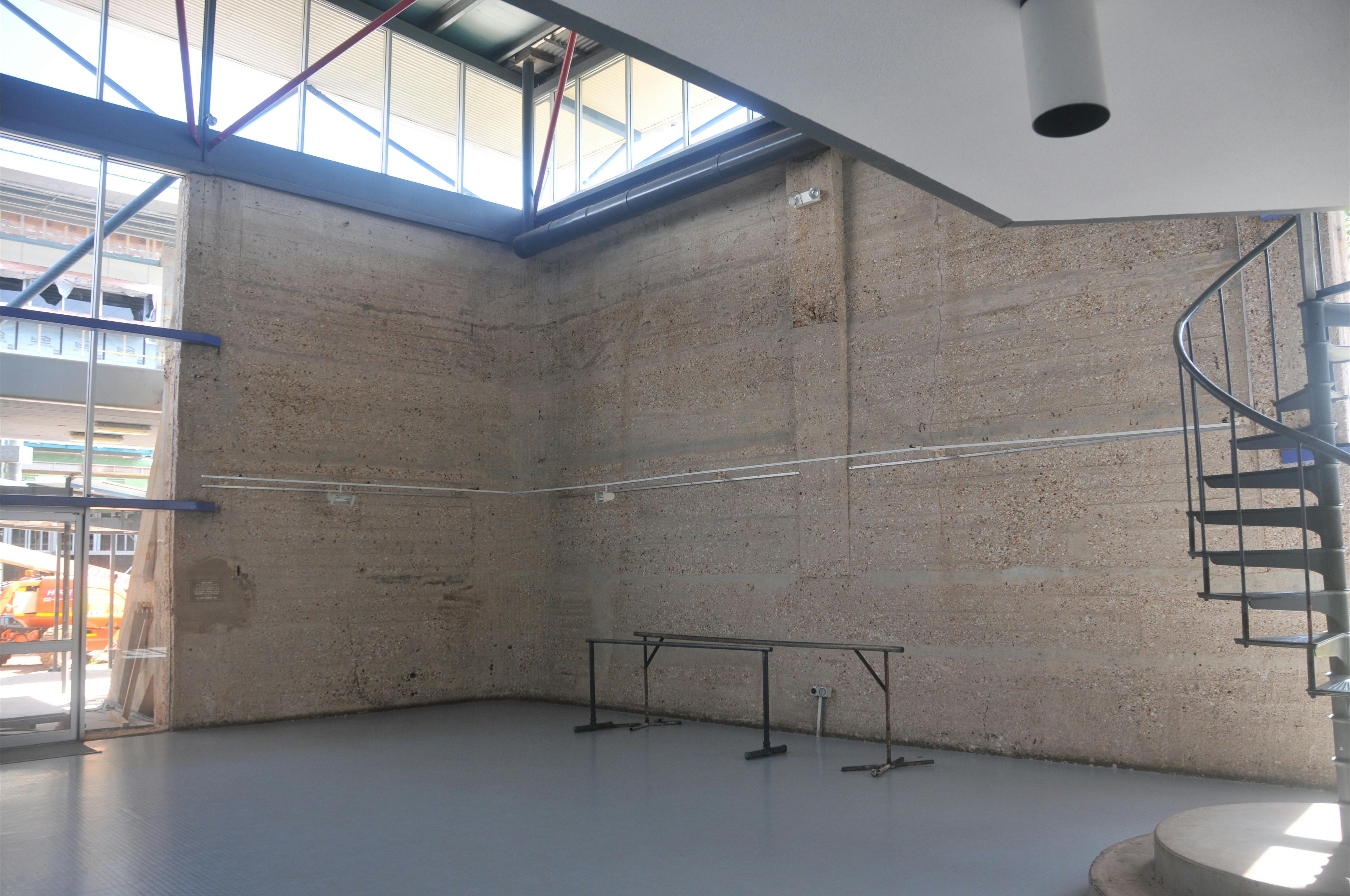 Interior of the tank showing original walls of the water tank, spiral stairs and new roof.