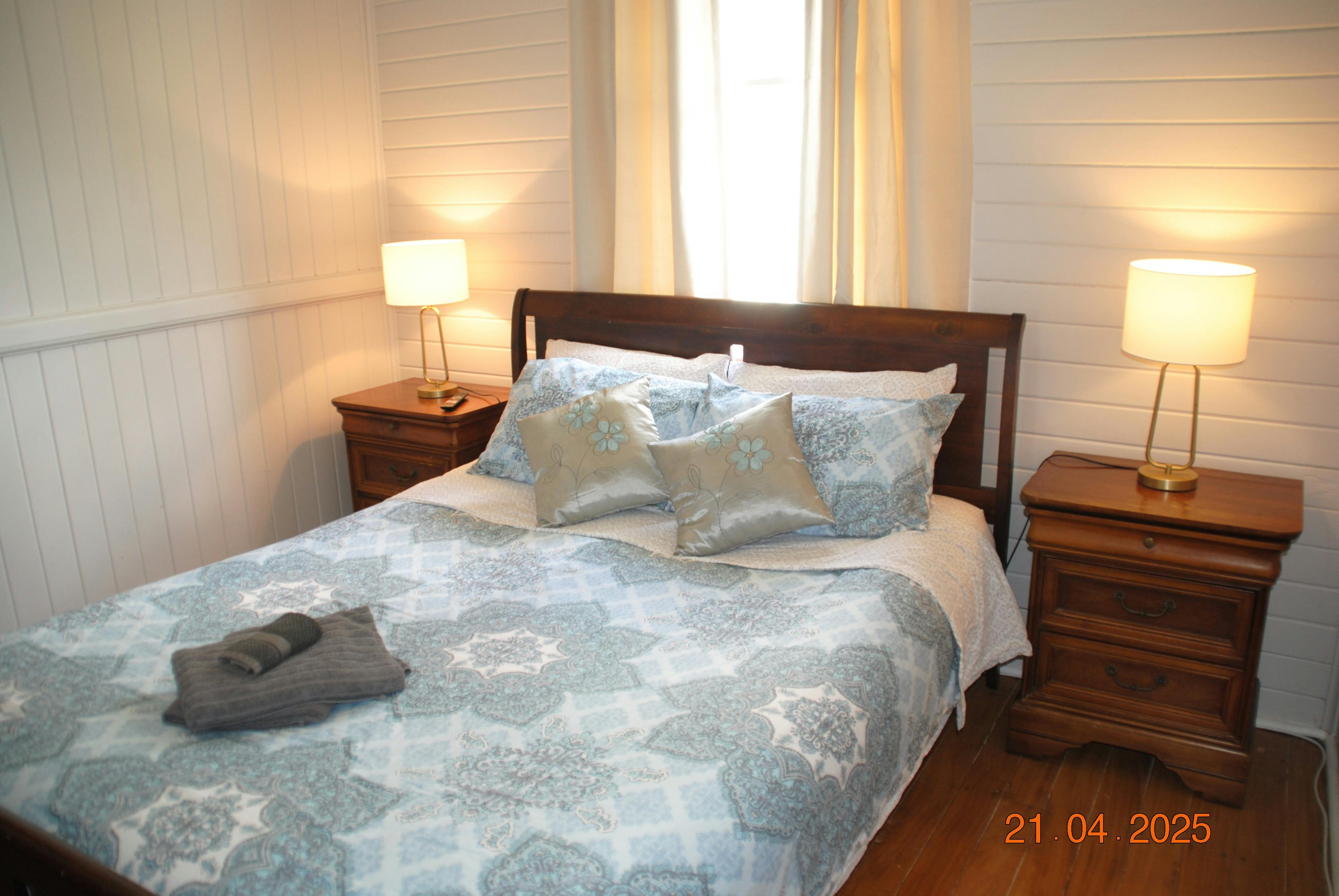 Traditional bedroom suite with queen bed, plenty of storage and reverse cycle airconditioner
