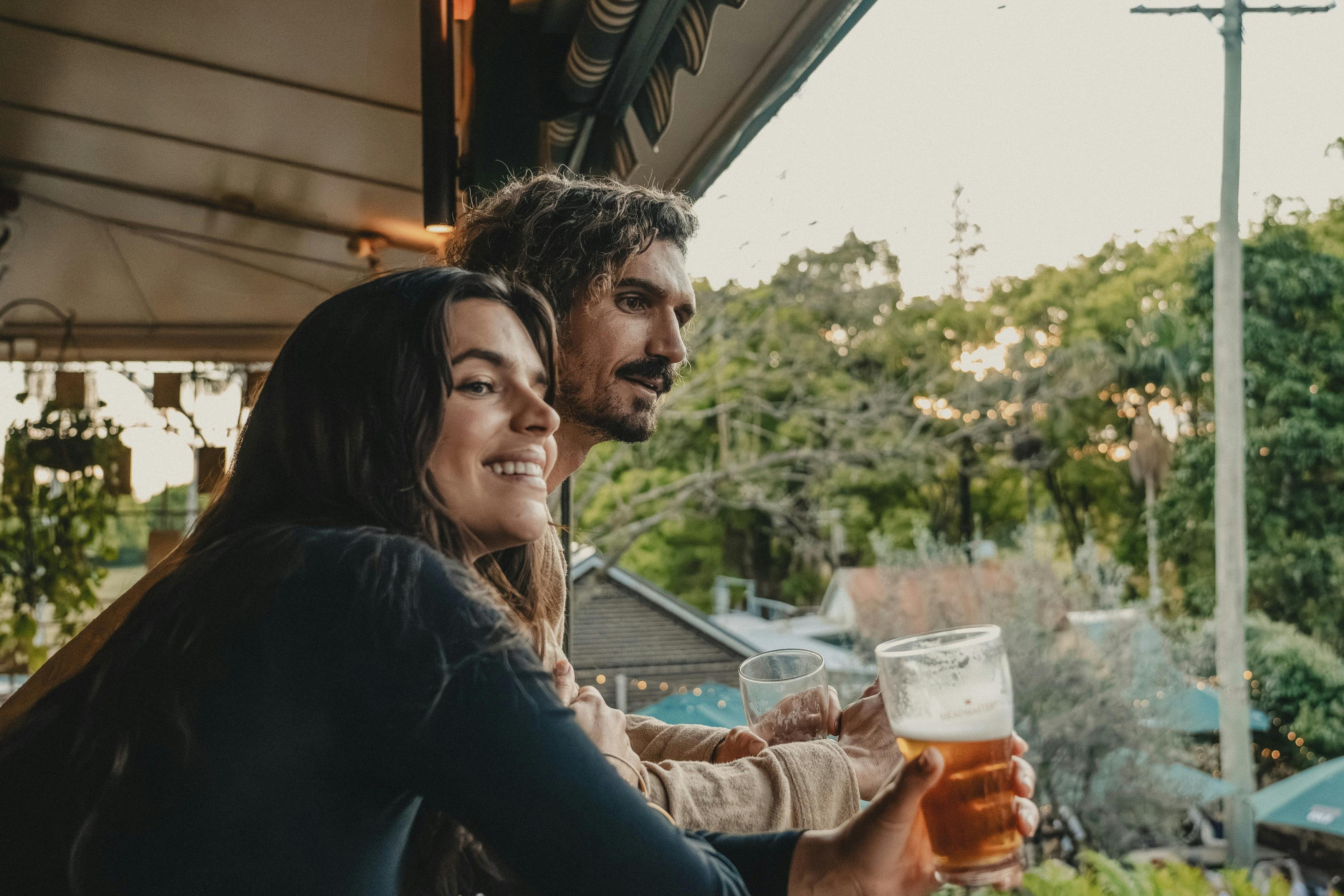Couple enjoying a drink from the balcony