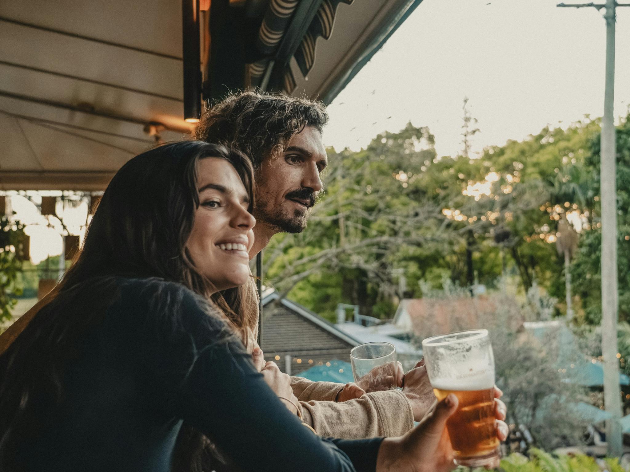 Couple enjoying a drink from the balcony