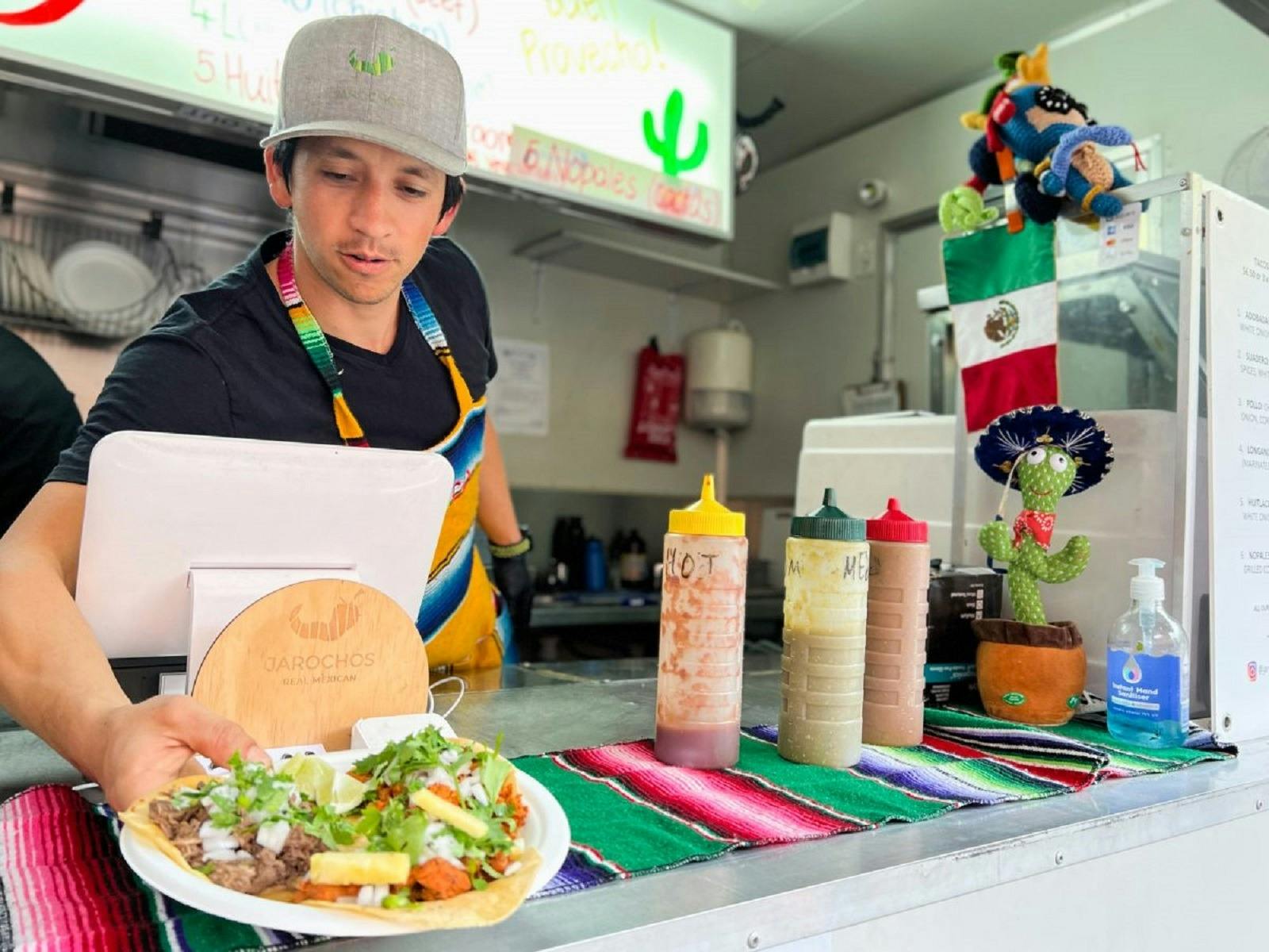 Man serving tacos from food truck