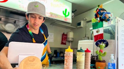 Man serving tacos from food truck