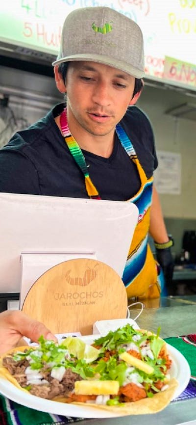 Man serving tacos from food truck