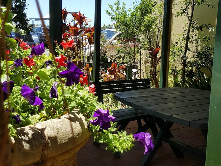 The Gallery's shady garden opposite the Myall River.