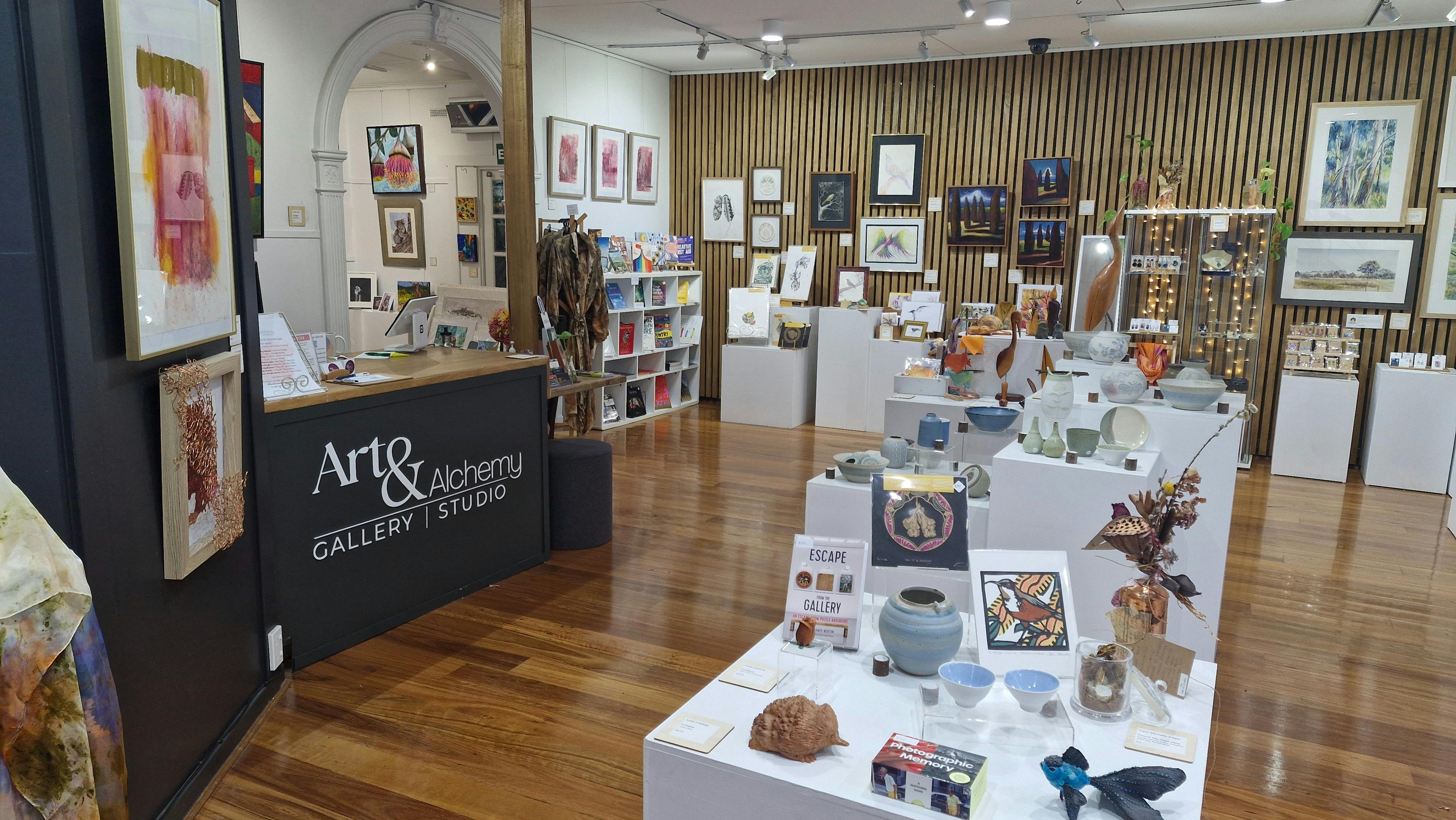 The inside of Art & Alchemy Gallery & Studio  with promenent signage visible
