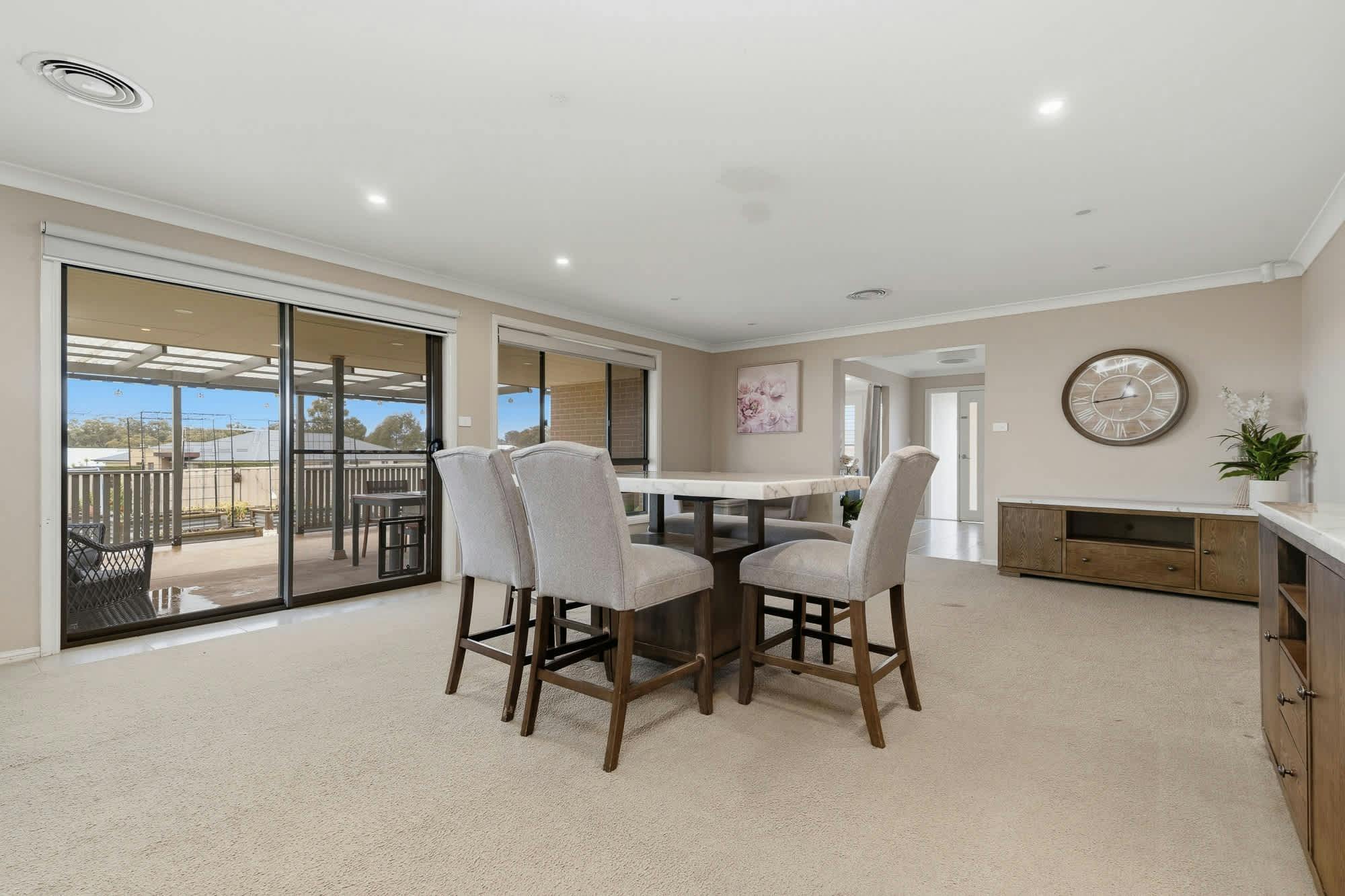 Dining table with 6 chairs, large sliding doors to outside