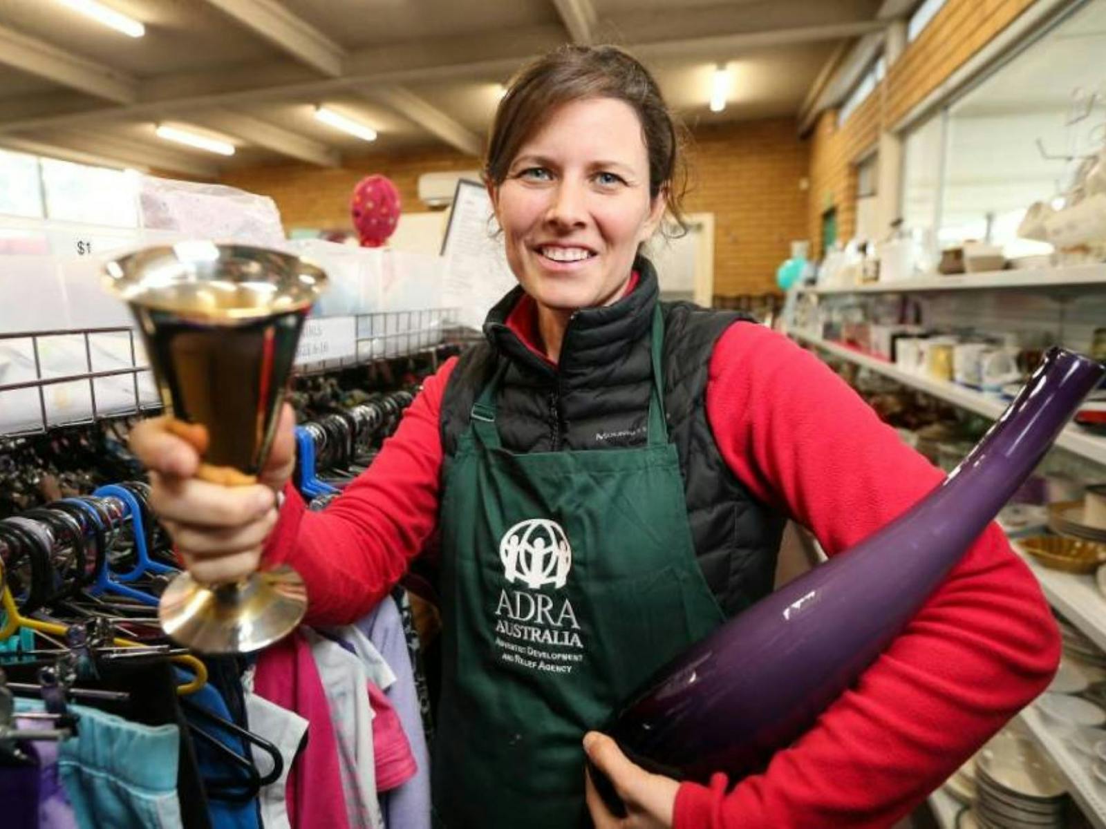 Image of a ADRA volunteer with items for sale in her hand