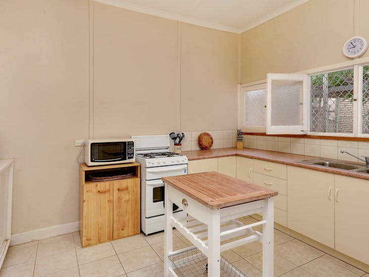 A fully equipped kitchen. Gas oven and cooktop. Full size fridge and a microwave.