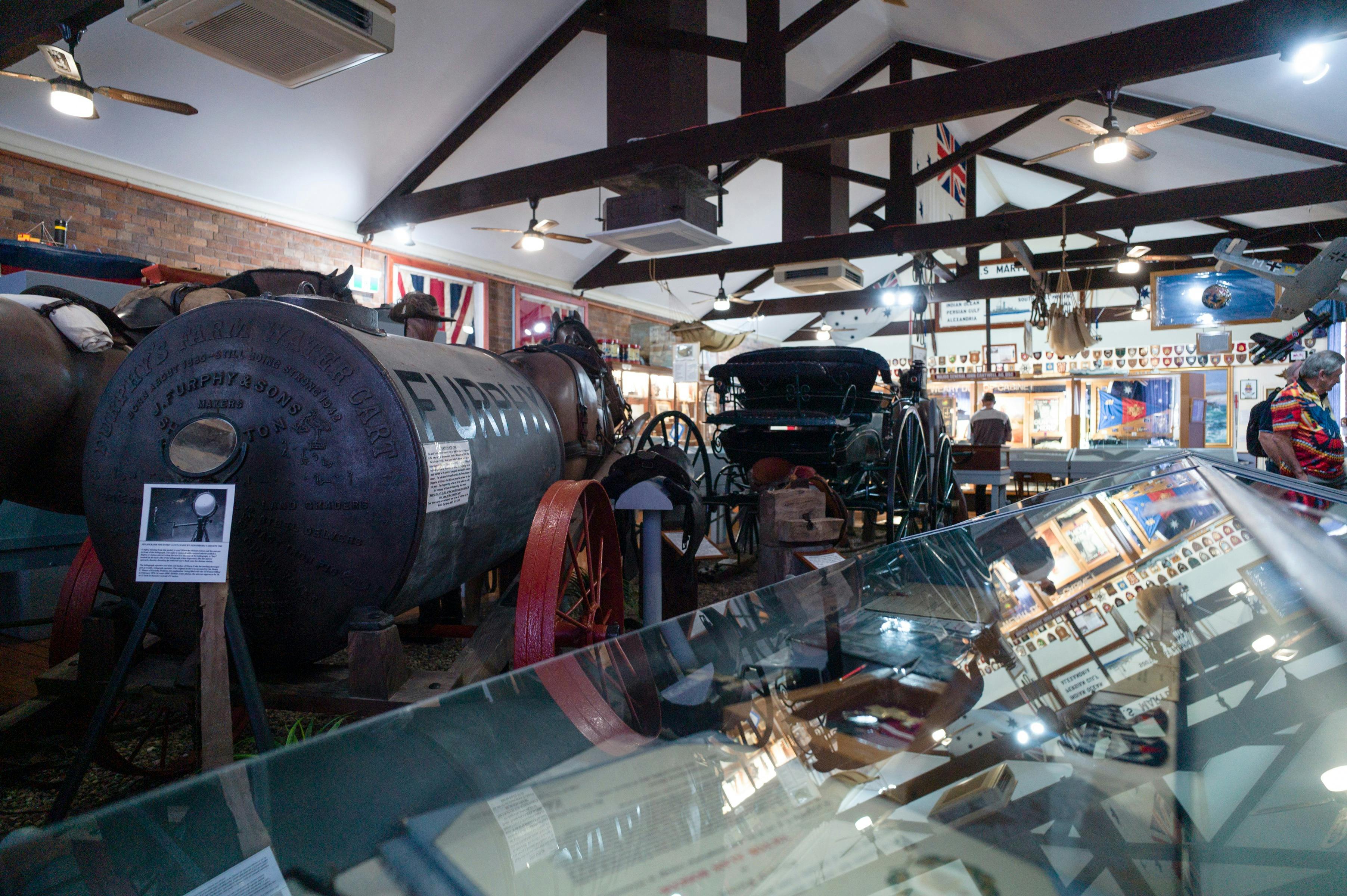 Photo inside MaryboroughMilitary Museum showing old items such as a Furphy water carrier from WW1