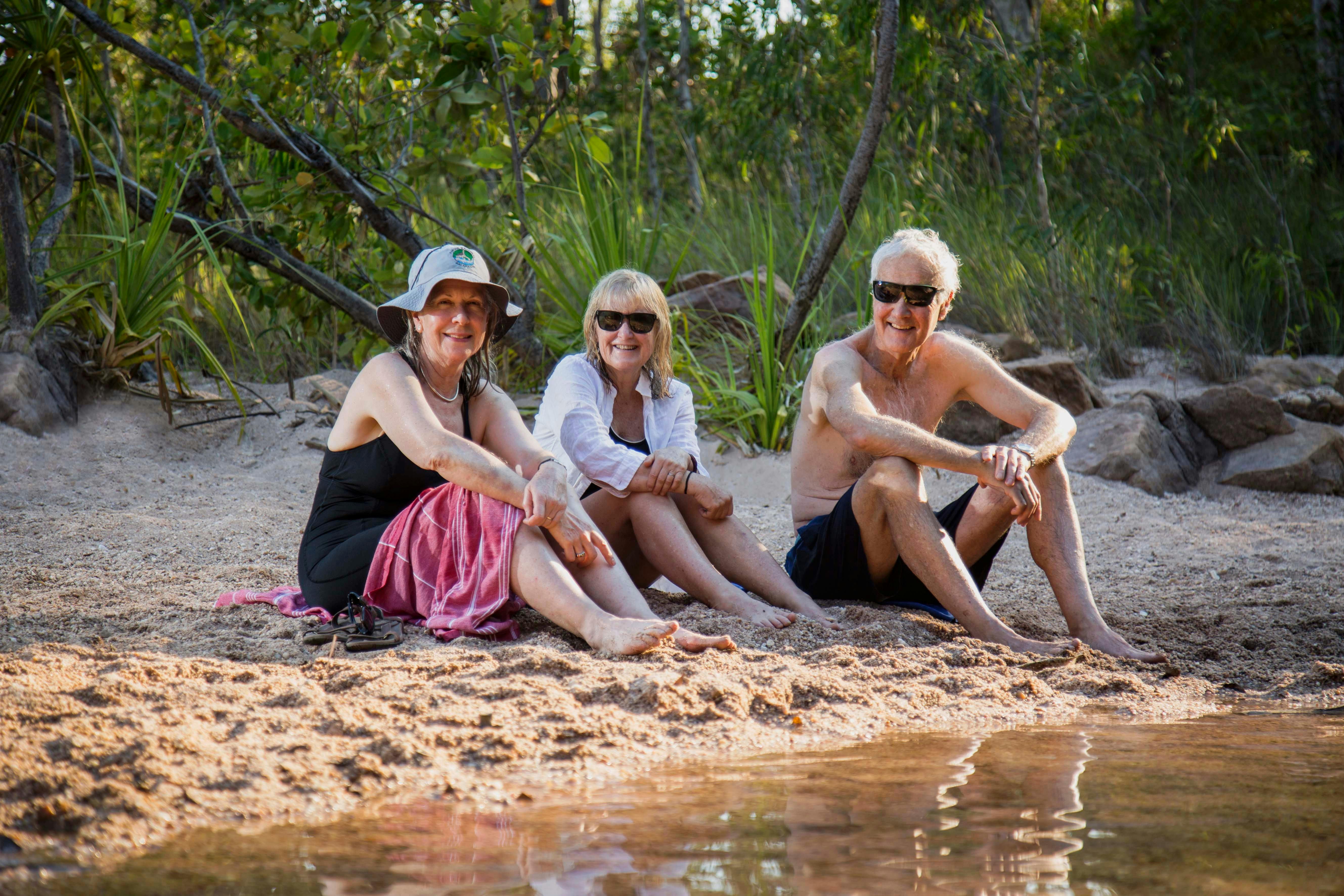Trekkers relaxing by a waterhole on the Kakadu Walking Adventure