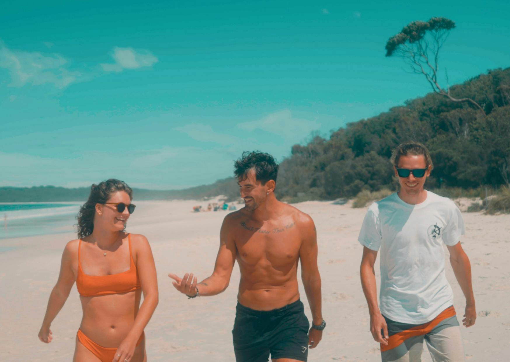 Three people walking on the beach