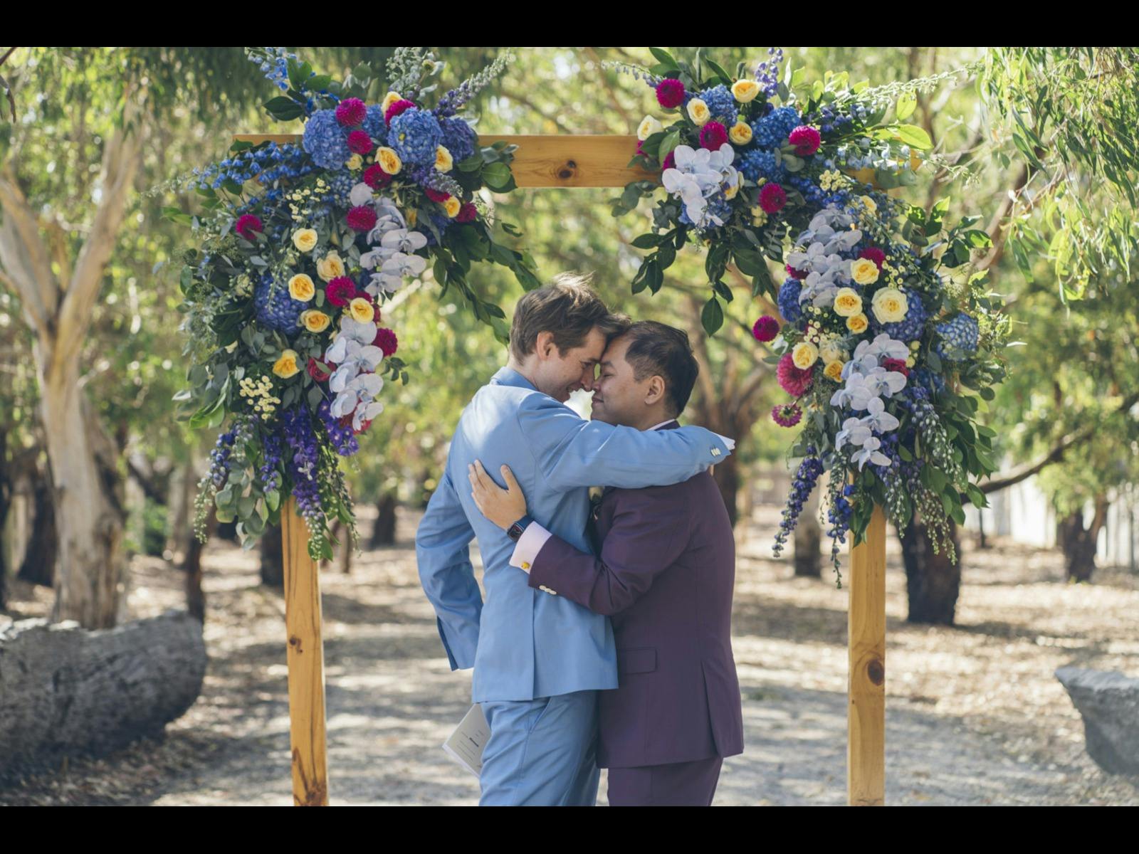 Two gorgeous grooms celebrating the moment of getting married
