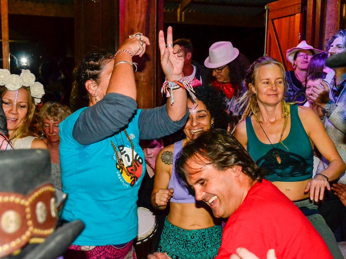 People dancing in a group and looking happy, laughing and smiling