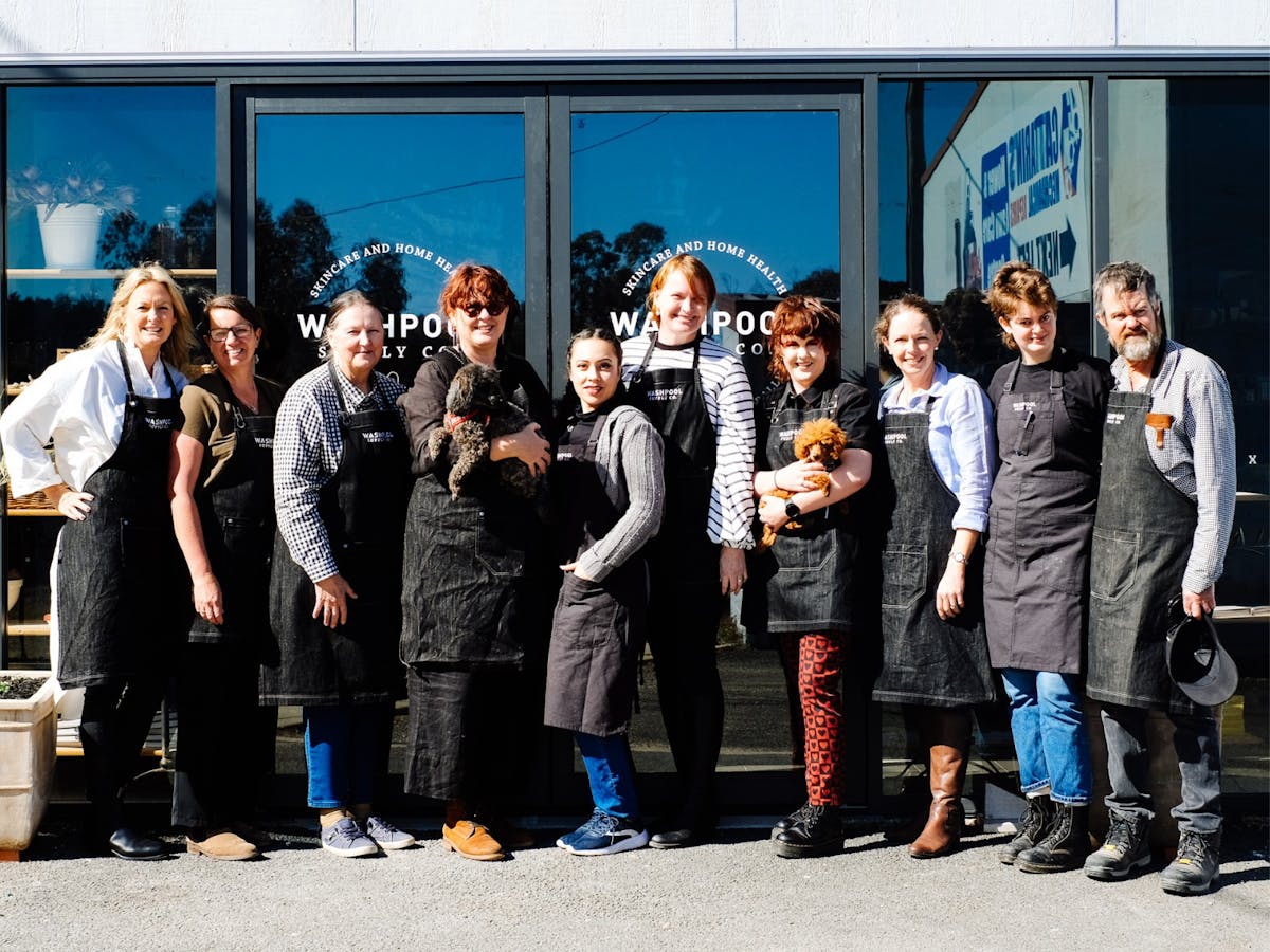 Image of the Washpool team standing in front of the entrance doors.