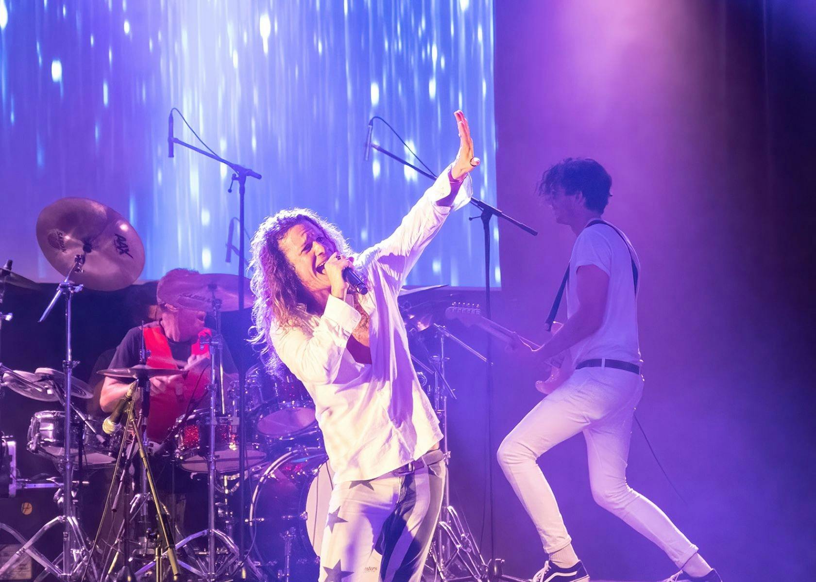 Dellacoma Rio as Michael Hutchence performing on stage.