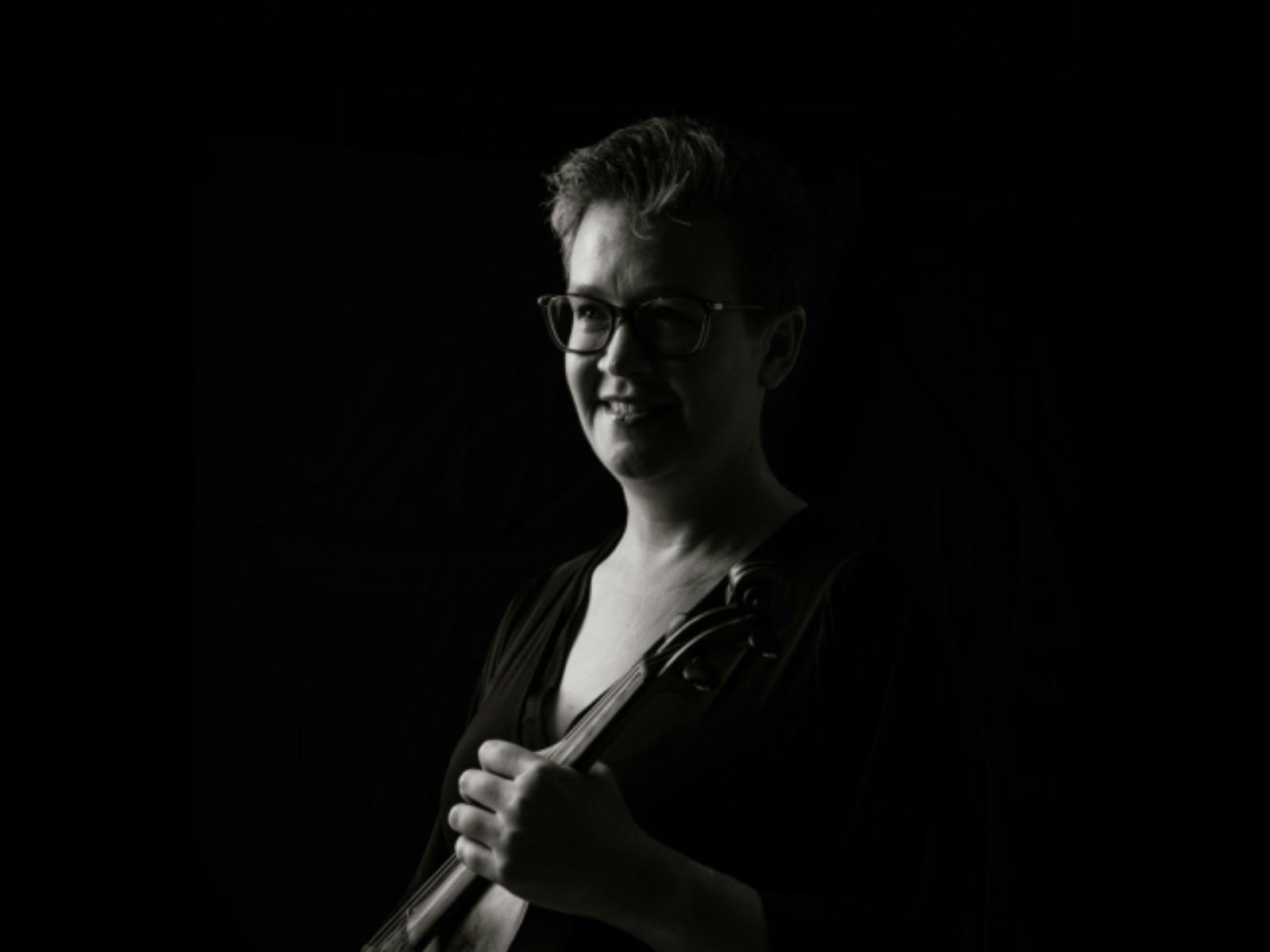 Black-and-white portrait of a violinist in profile, looking toward the light Black-and-white portrait of a violinist in profile, looking toward the light