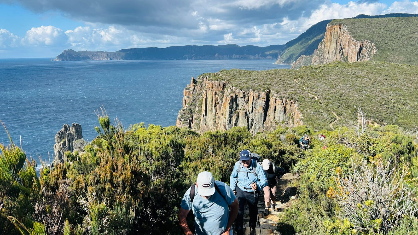 Walking together along the spectacular coastal trails of the Three Capes Walk Tasmania