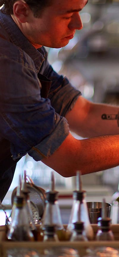 Barman lighting a cocktail on the bar