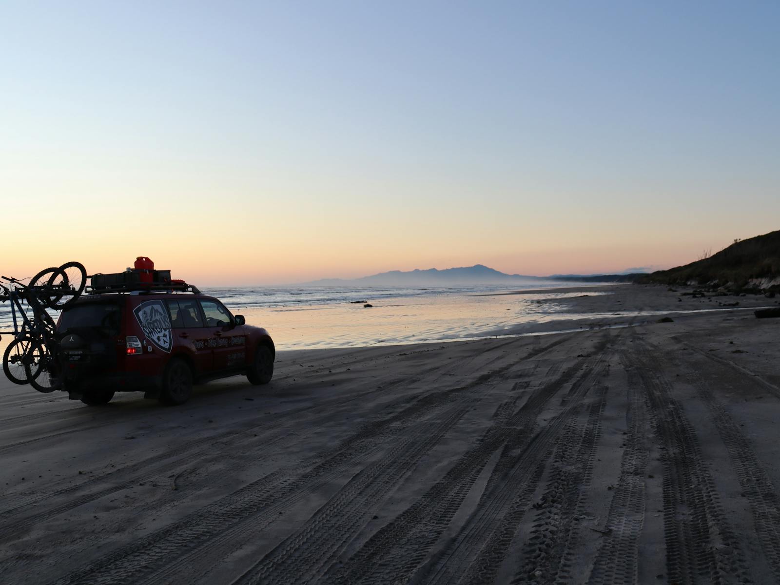 Tour vehicle 4x4 captured in a beach sun set
