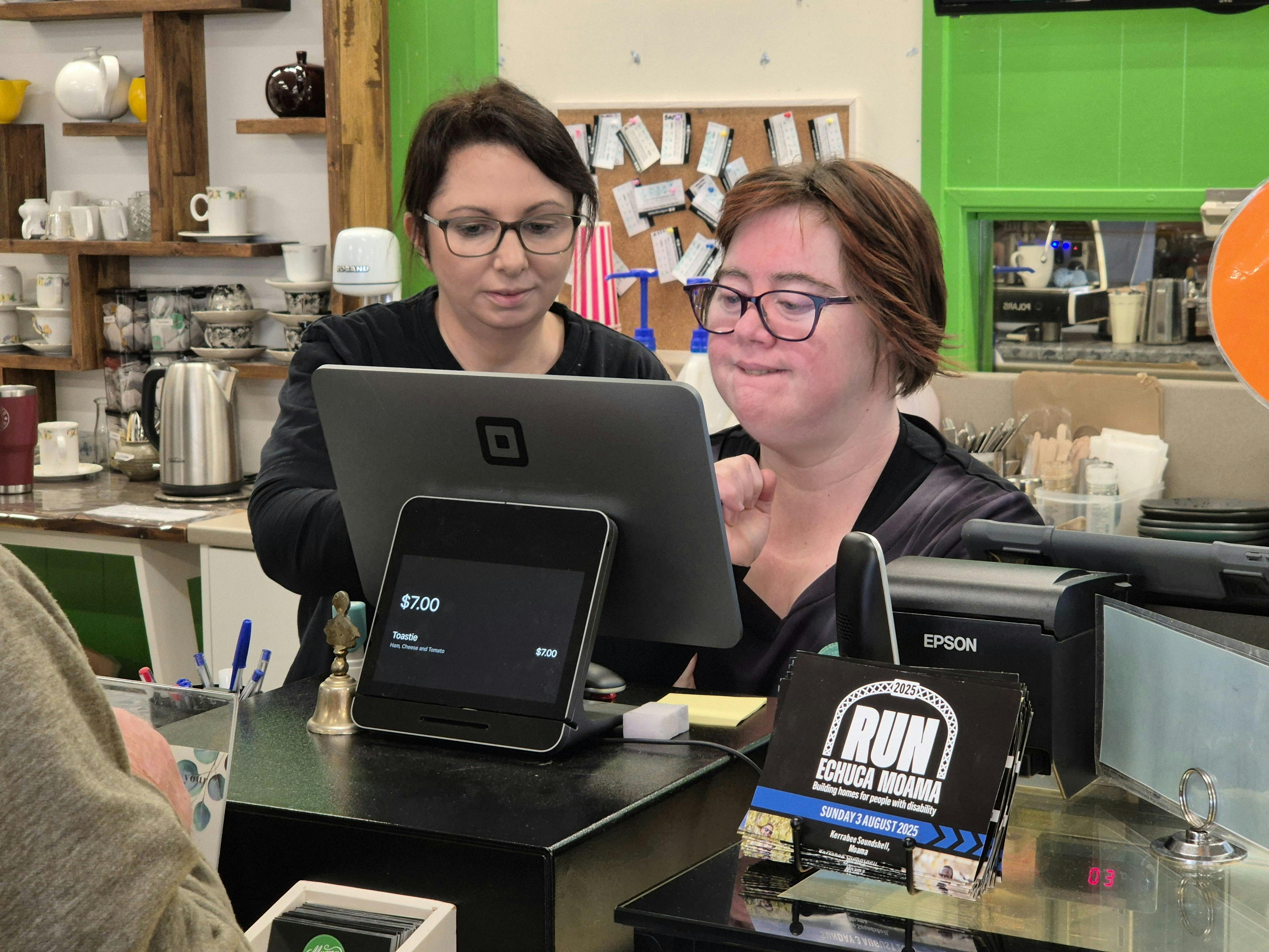 Supported volunteer Amelia taking a customer order using our Square POS