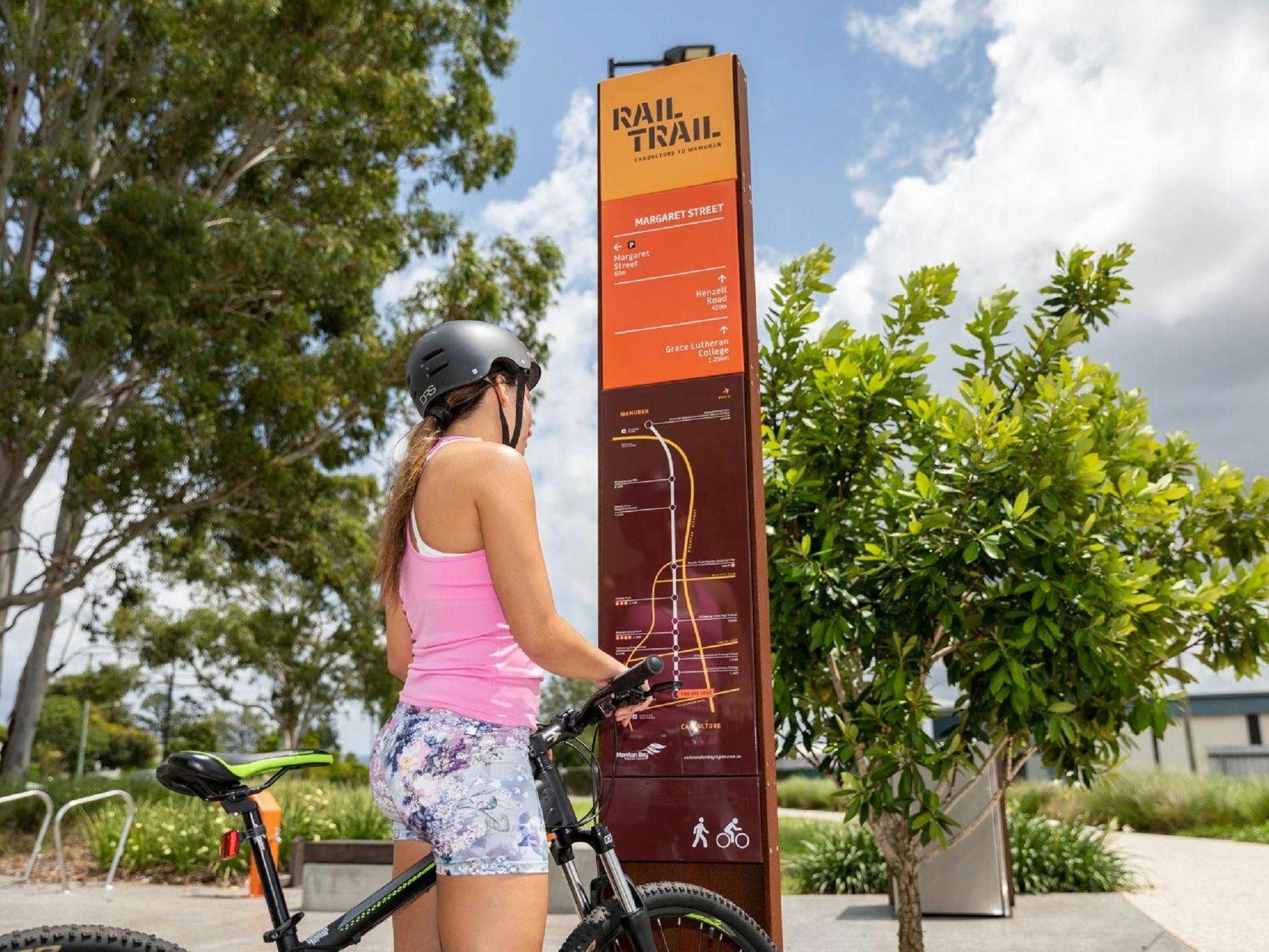 A girl looking at the map of the Caboolture to Wamuran Rail Trail A girl looking at the map of the Caboolture to Wamuran Rail Trail