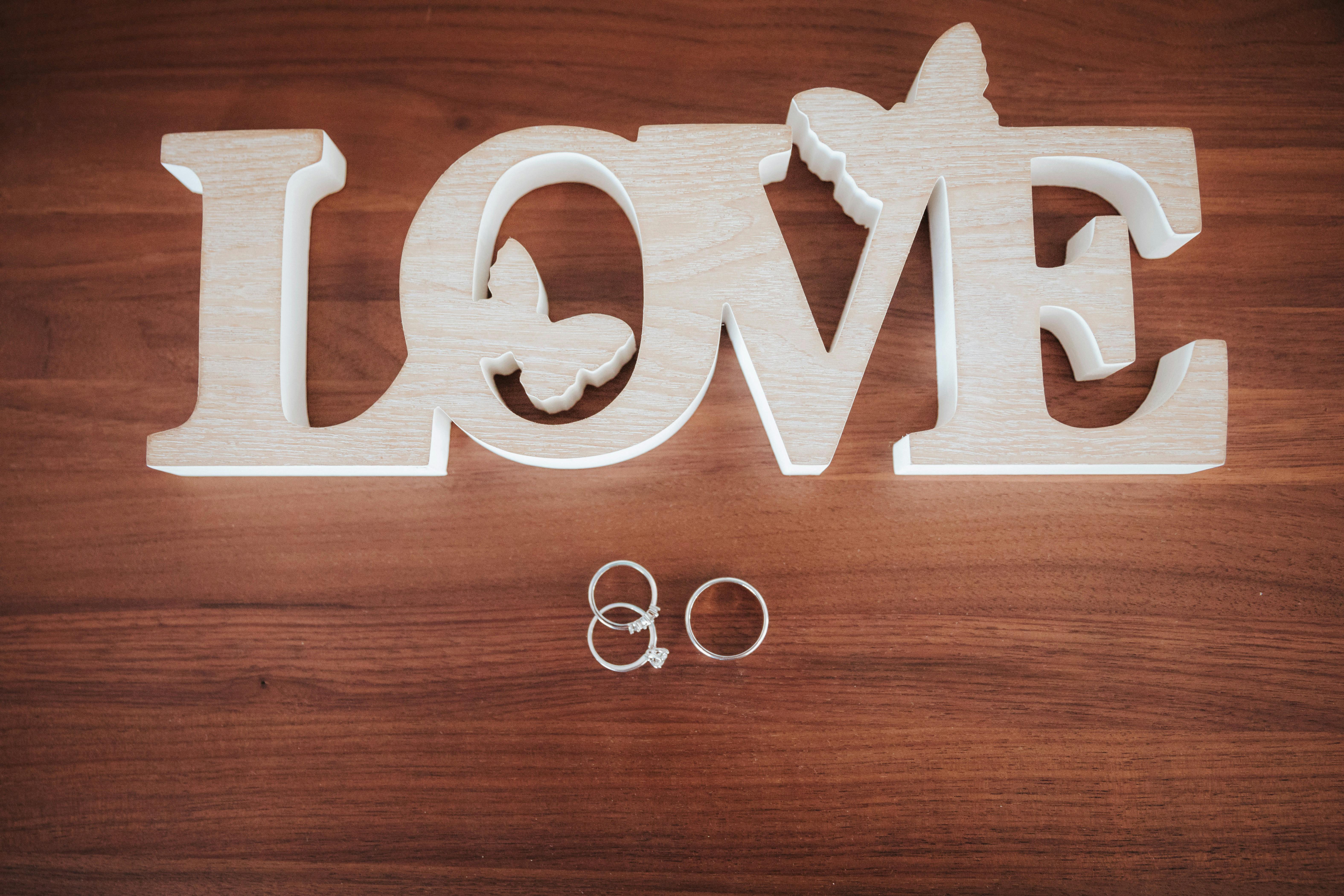 Lakeview Retreat - Wooden 'LOVE' sign with wedding and engagement rings