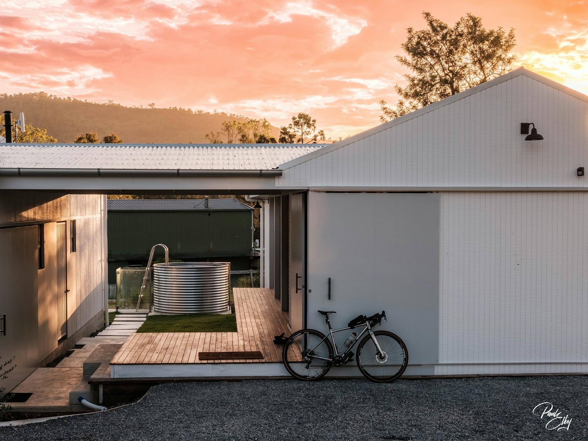 Rail Trail Refuge accom with plunge pool in the background & bike leaning at front at sunrise Rail Trail Refuge accom with plunge pool in the background & bike leaning at front at sunrise