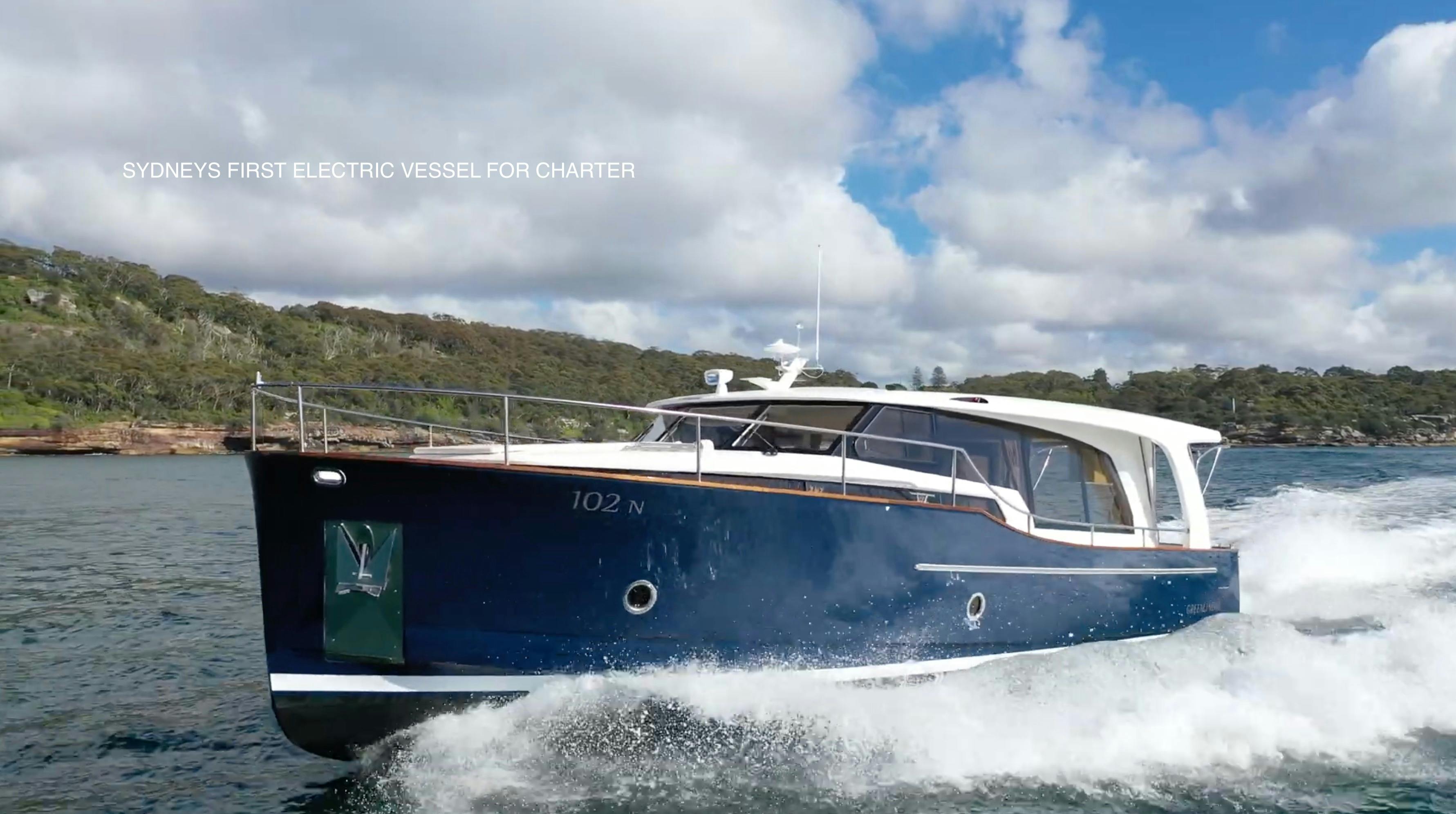 EV Arcadia electric luxury cruiser underway on Sydney Harbour national park foreshore
