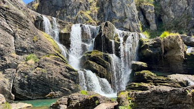 A waterfall leading into a pool of water.