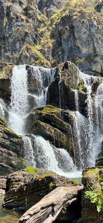 A waterfall leading into a pool of water.