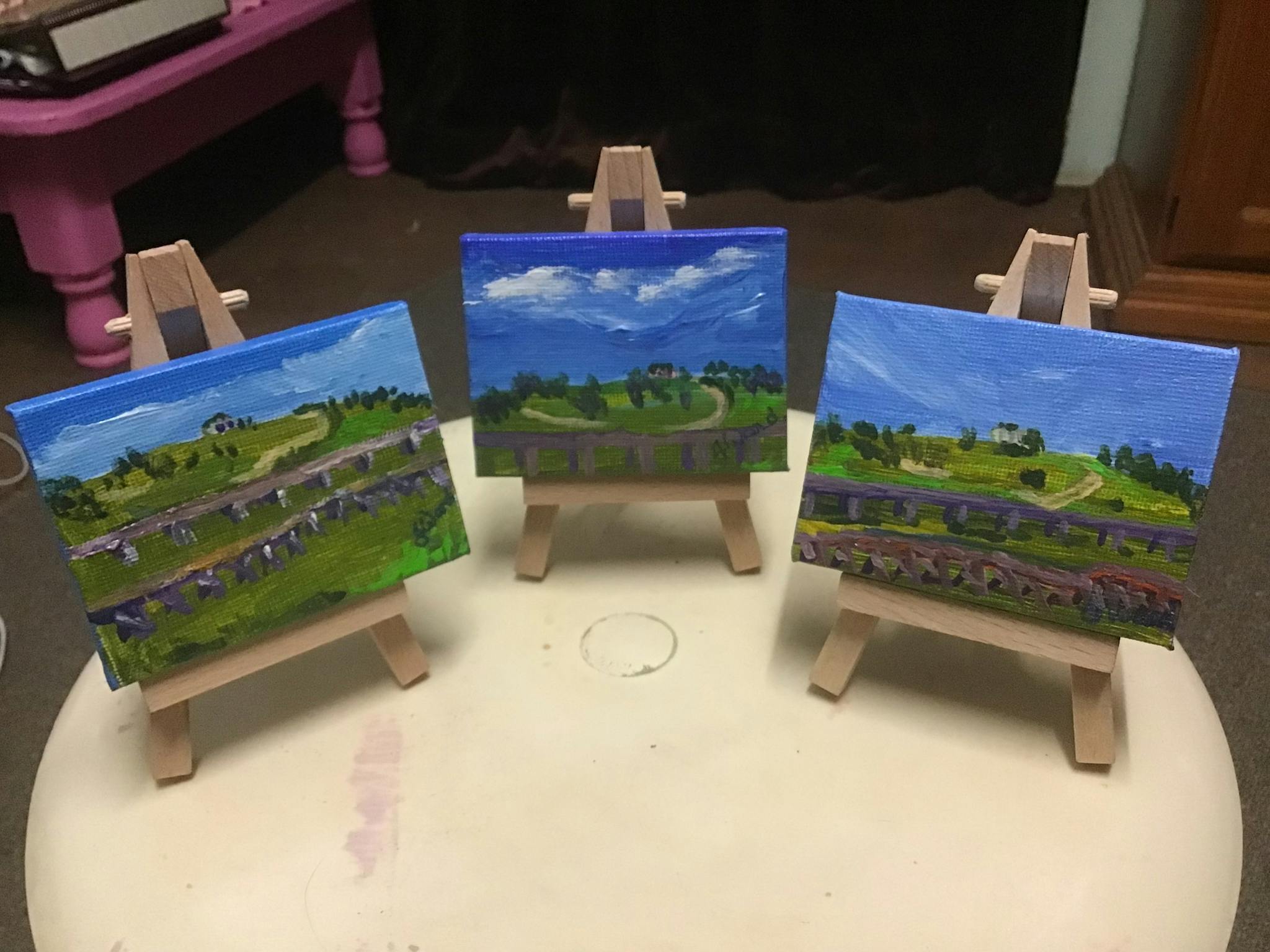3 tiny paintings on tiny easles