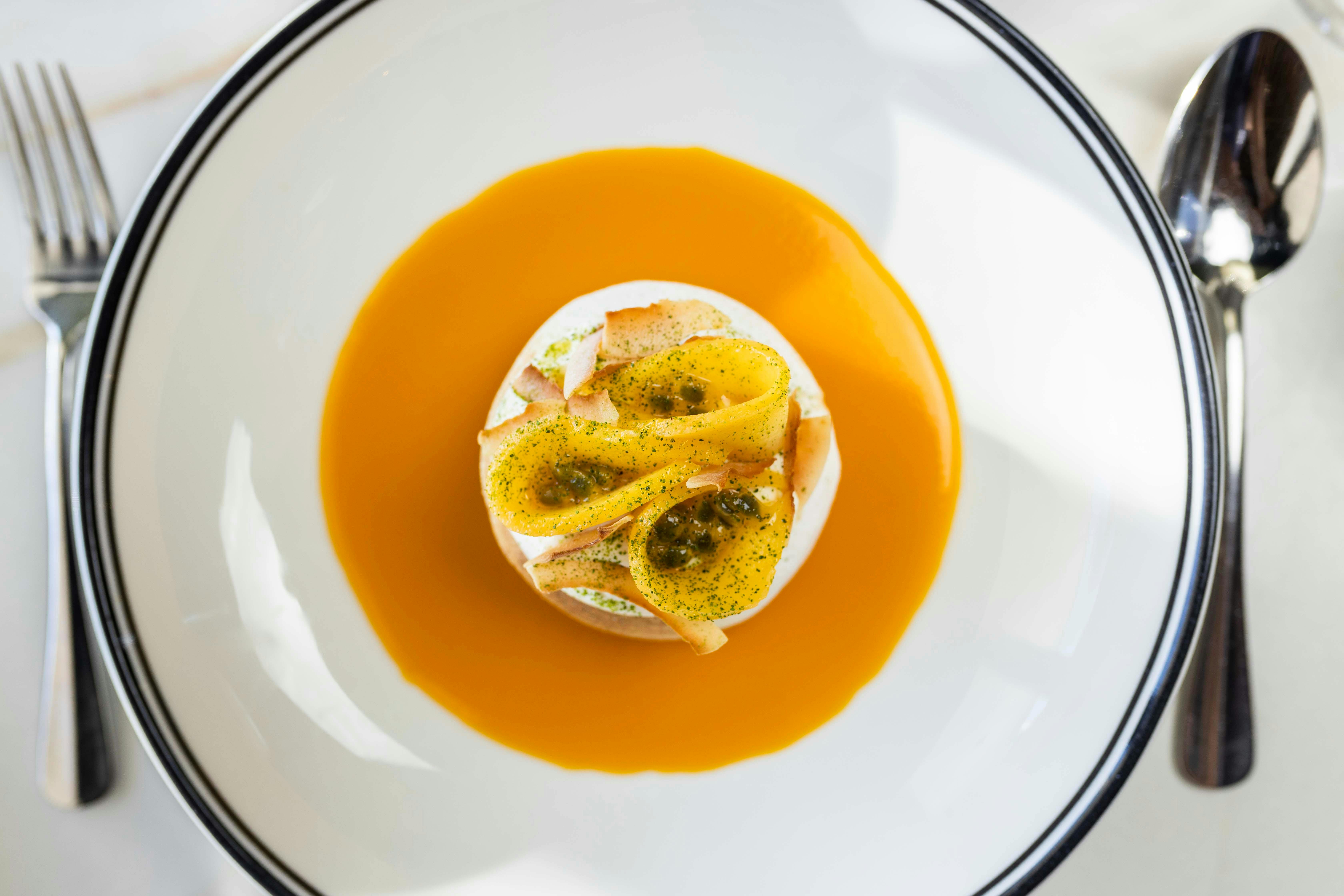 Summer pavlova, mango, passionfruit, coconut cream