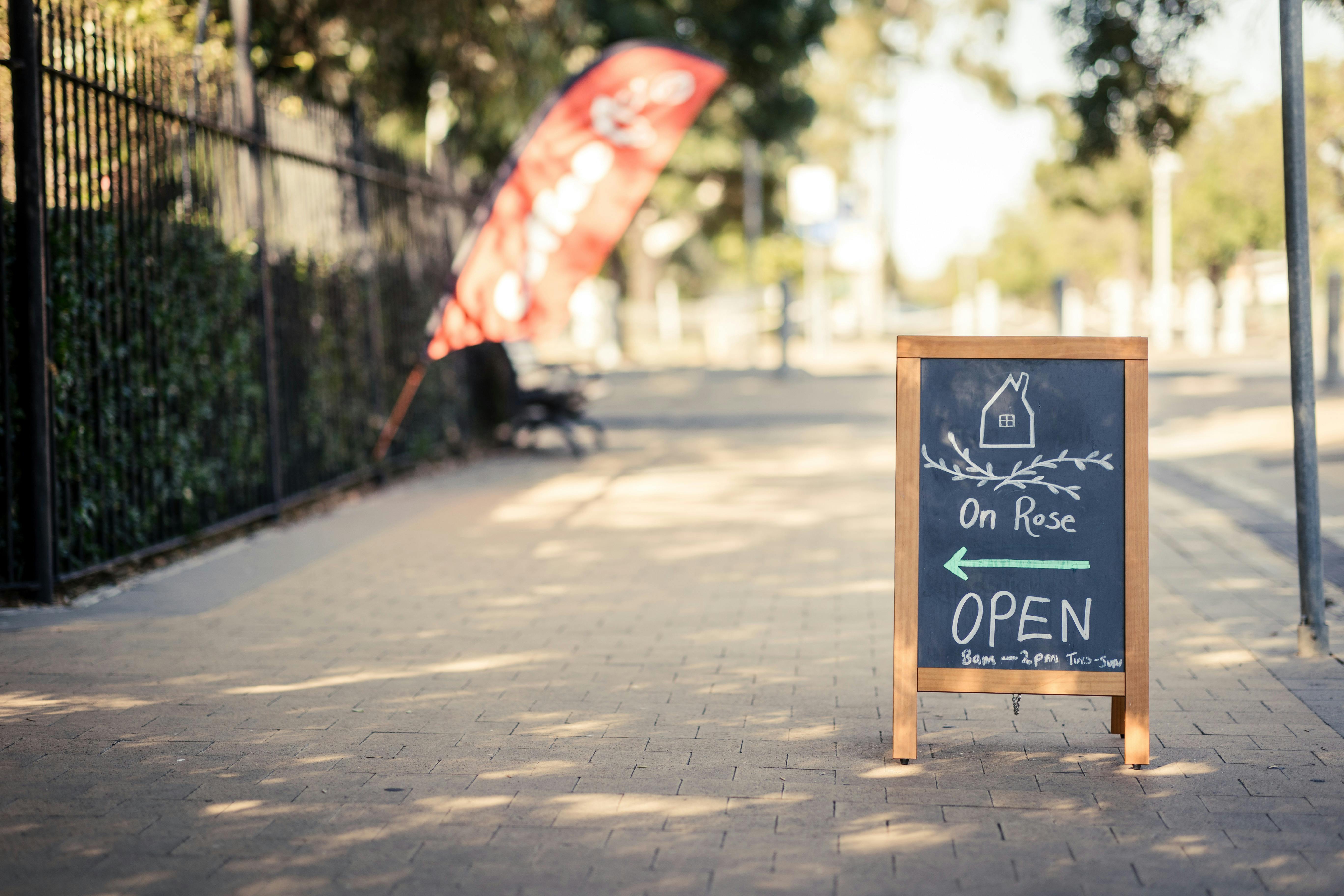 Cafe sign on paved footpath