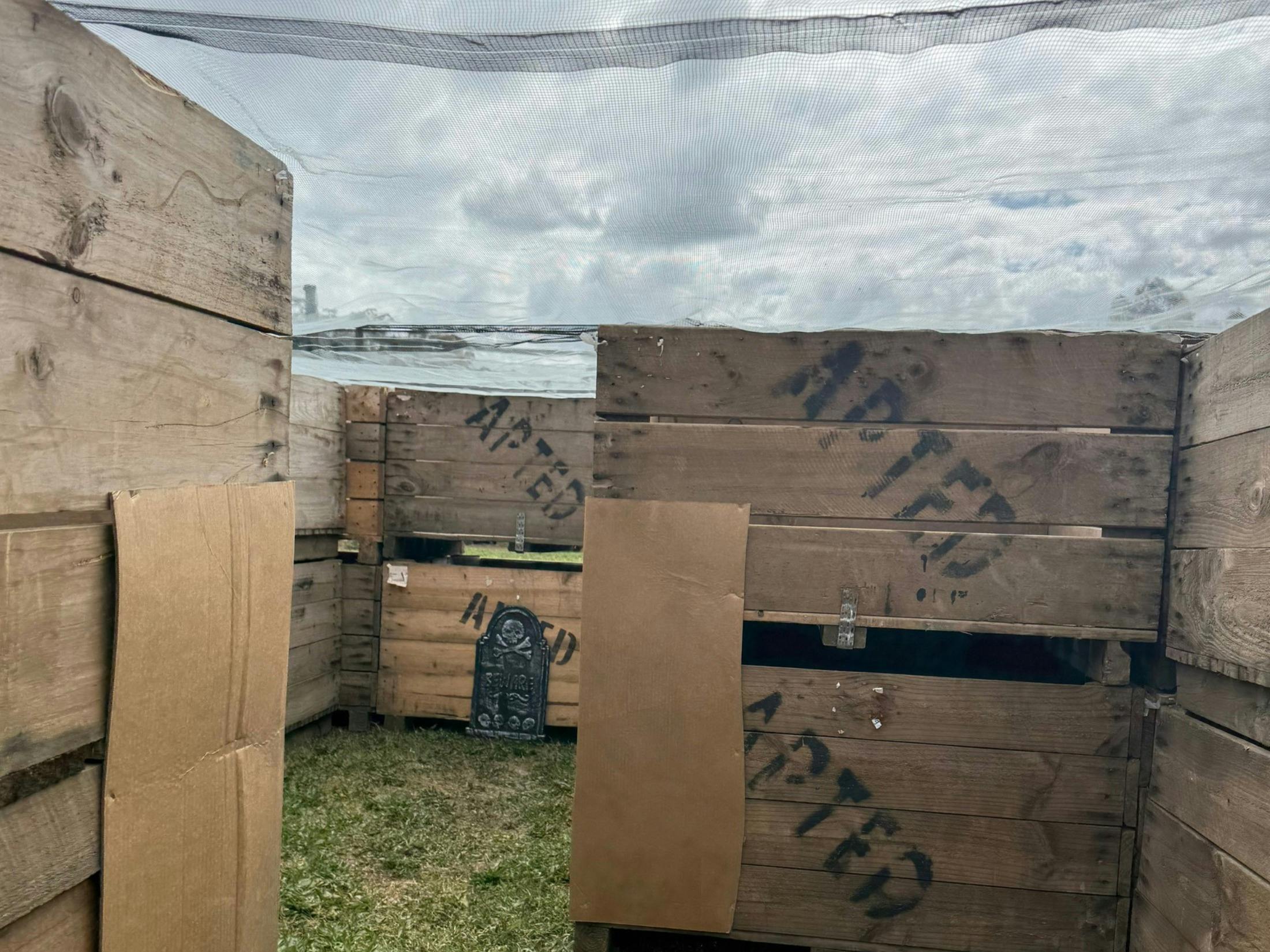 A maze made of old fruit bins, with Apted stamped on it