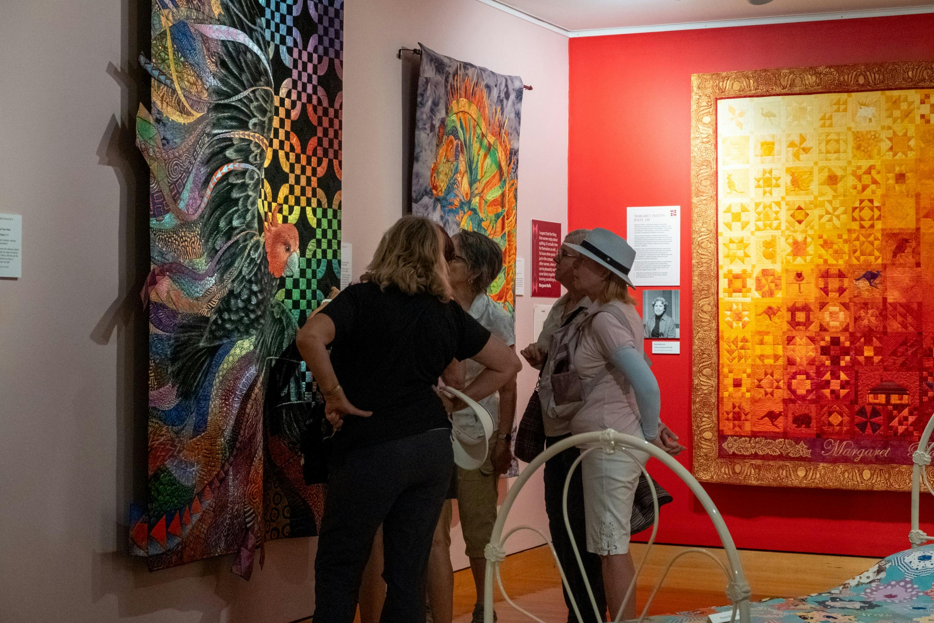 Group observing quilts at Stitching Stories