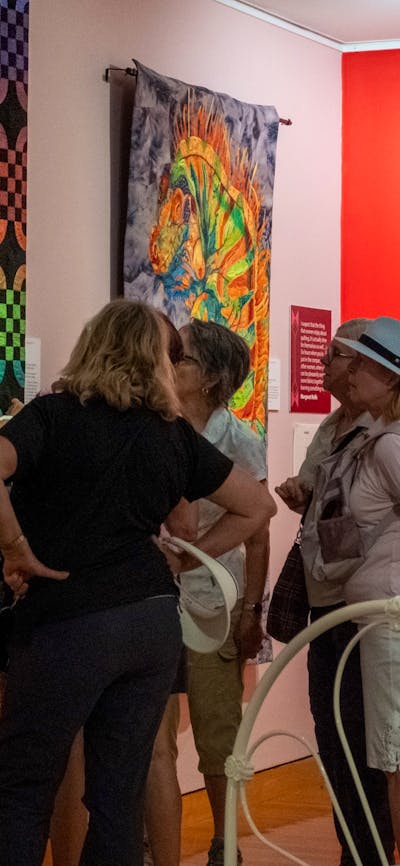 Group observing quilts at Stitching Stories