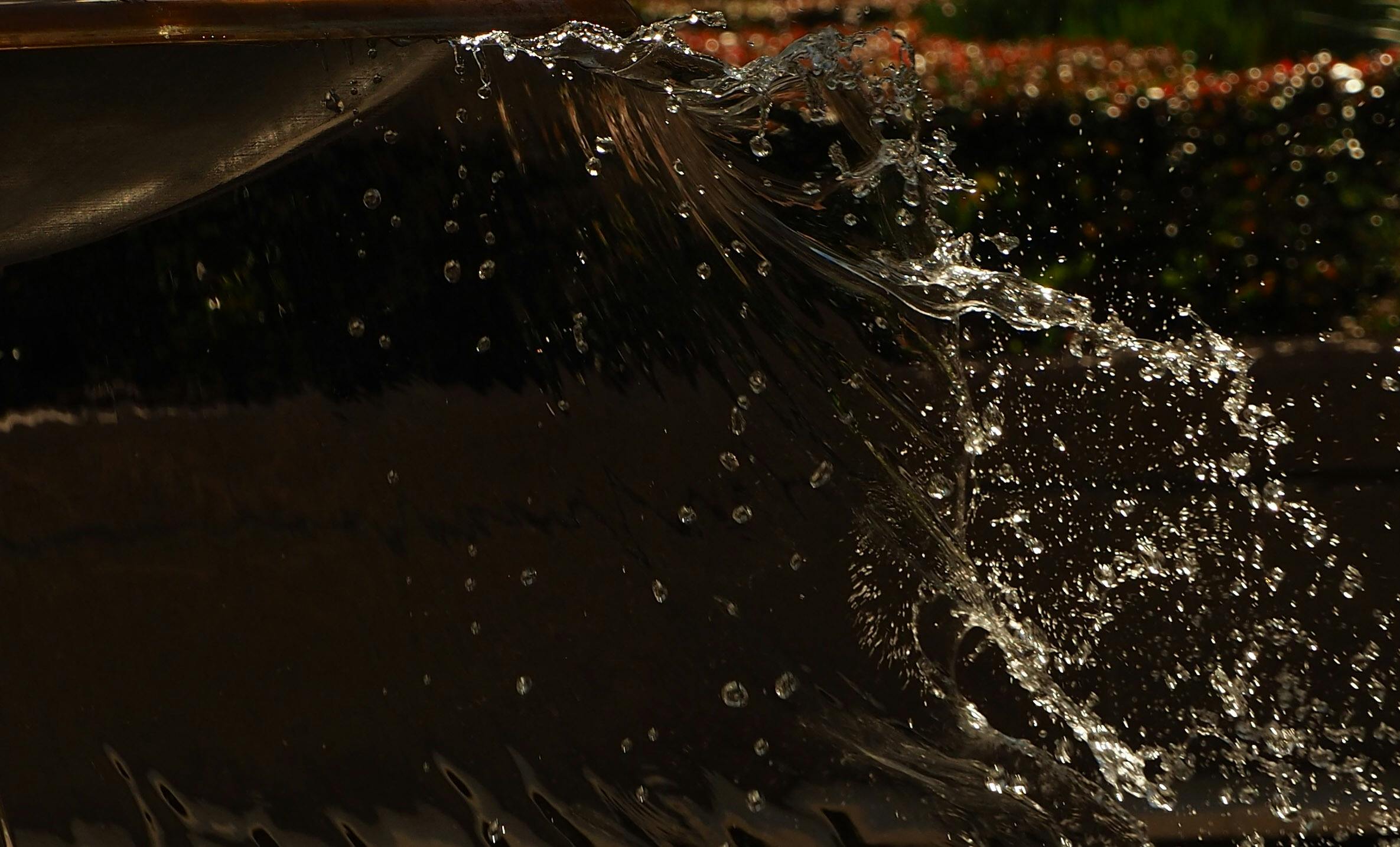 high speed photo freezing water droplets from a fountain in mid air