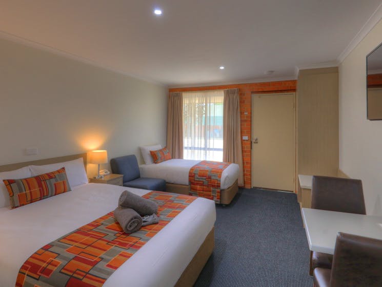Executive Twin Room fully renovated with one queen bed and one single bed, table & chairs