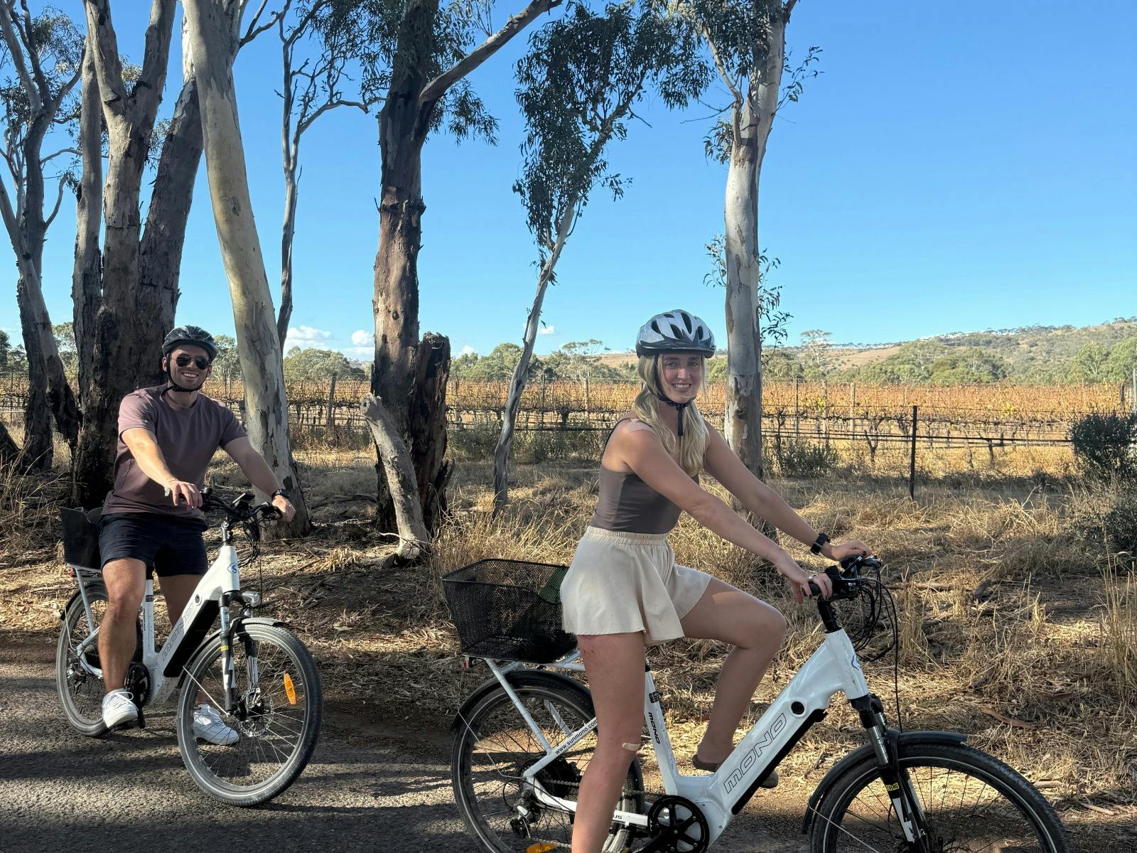 Two young adults on eBikes in McLaren Vale