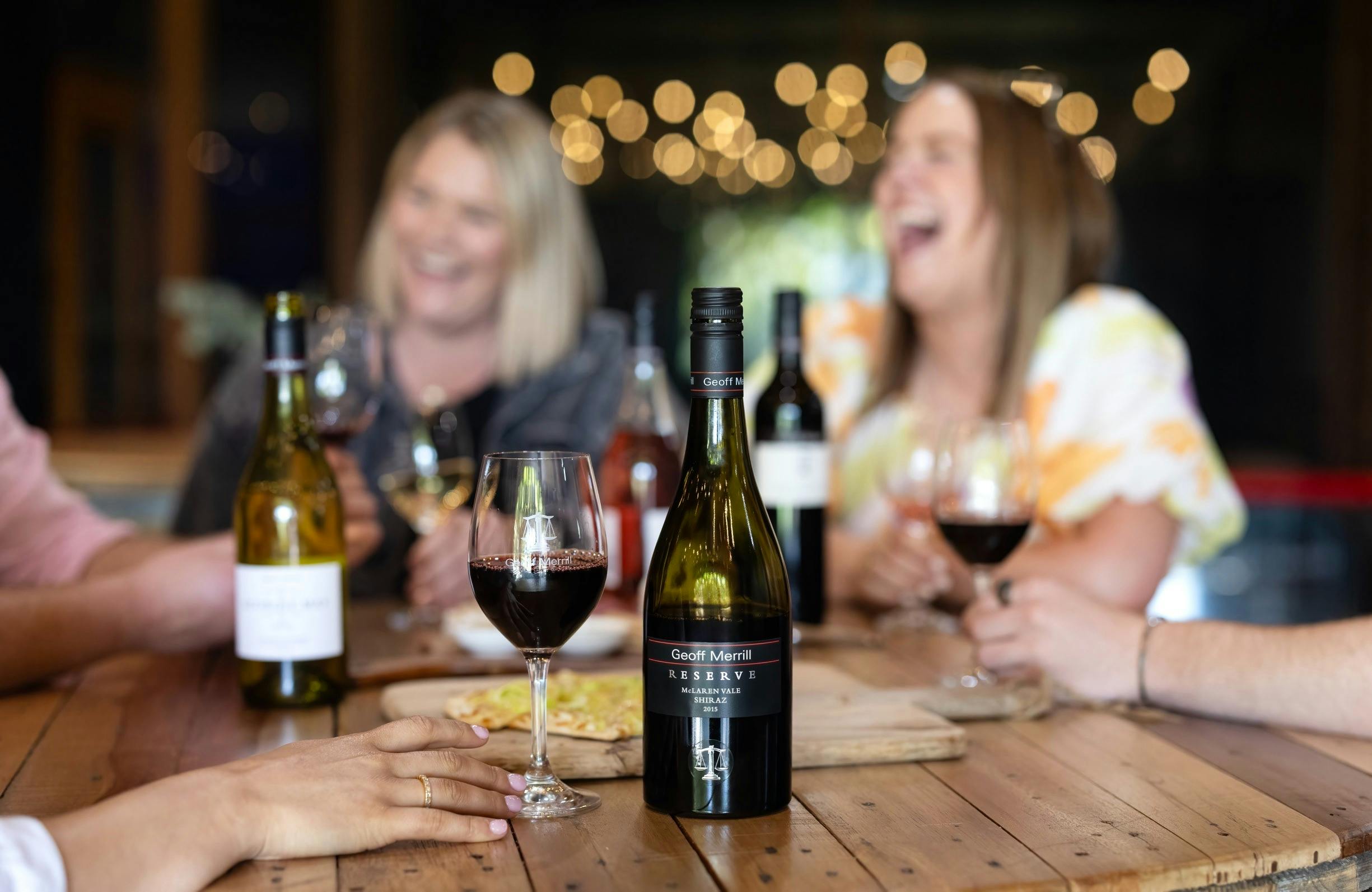 A group laughing around wines