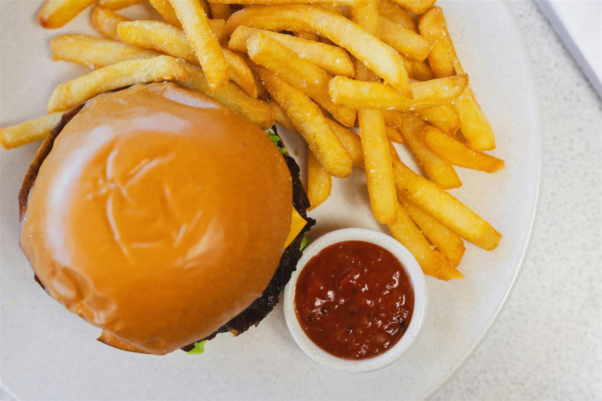 signature burger at cardon served with chips or salad at pelican waters golf club