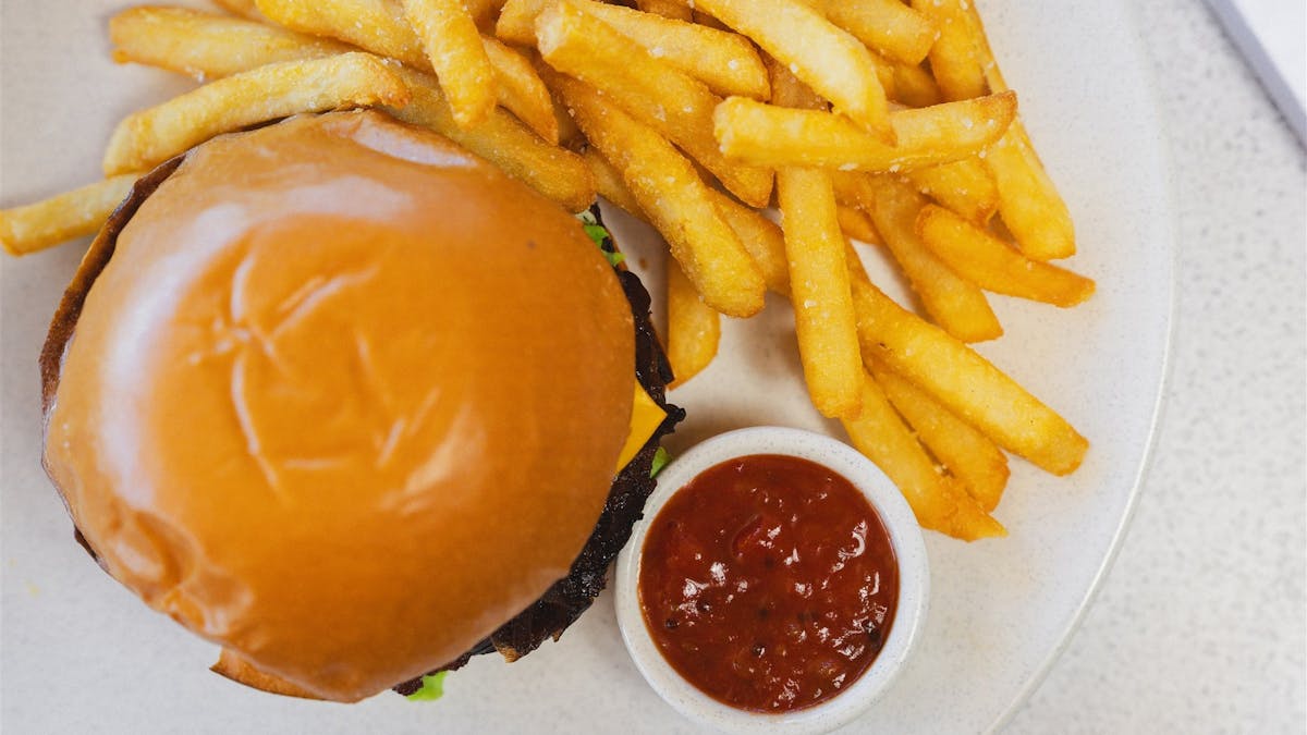 signature burger at cardon served with chips or salad at pelican waters golf club