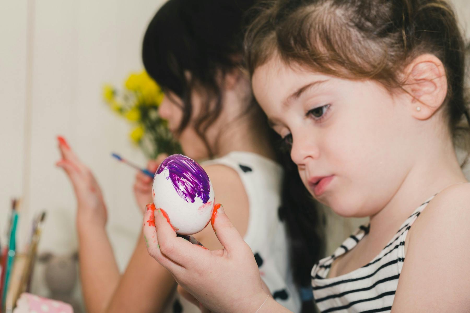 Girl painting egg