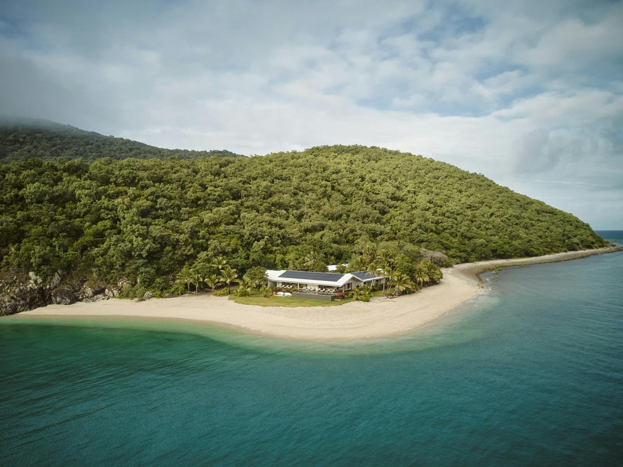 Image of private island with dense bush white sand and blue water Image of private island with dense bush white sand and blue water