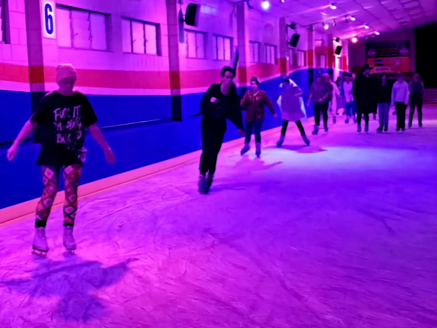 Ice Skaters in a purple lit rink
