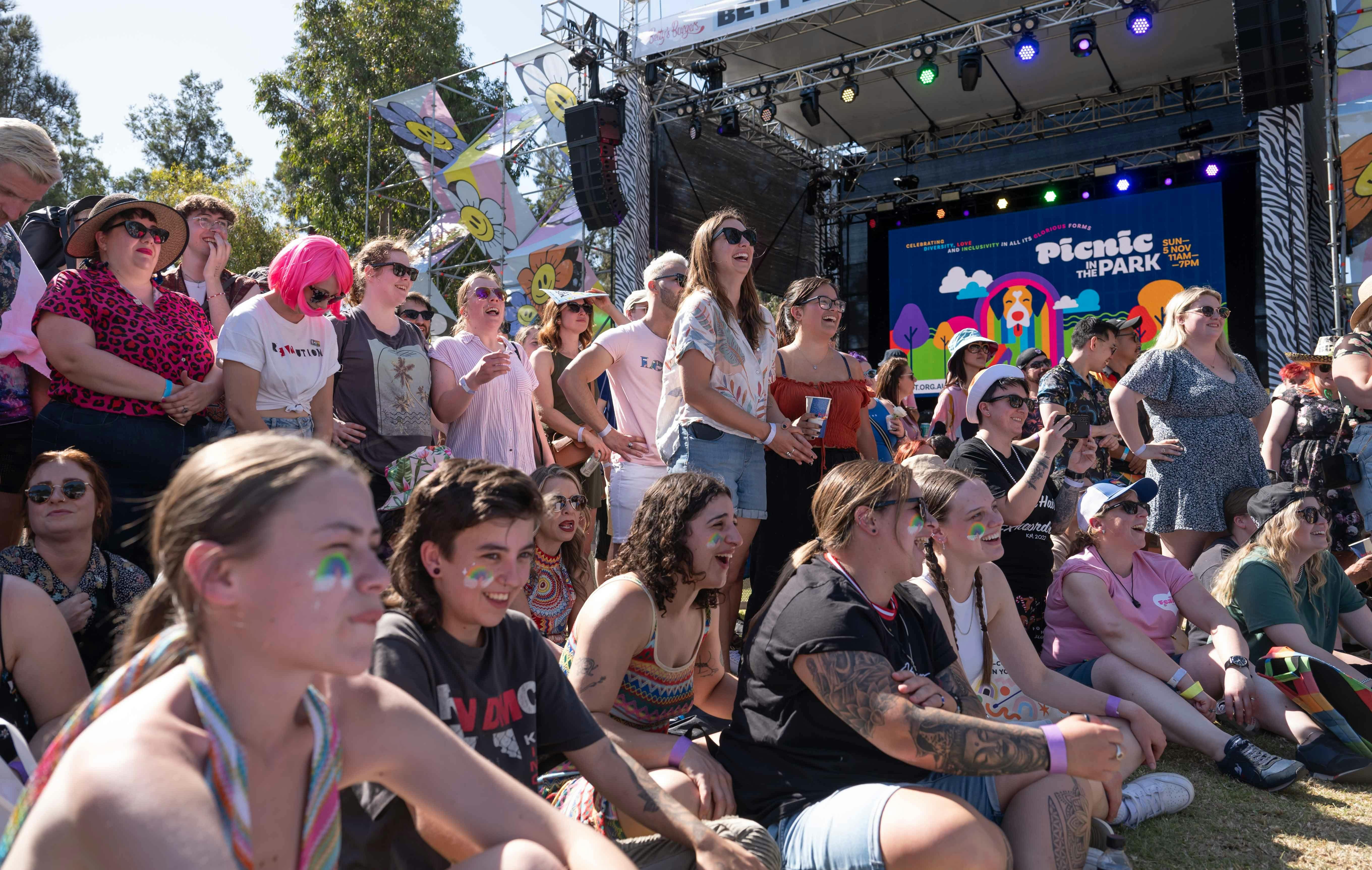 A crowd of people talking and laughing.
