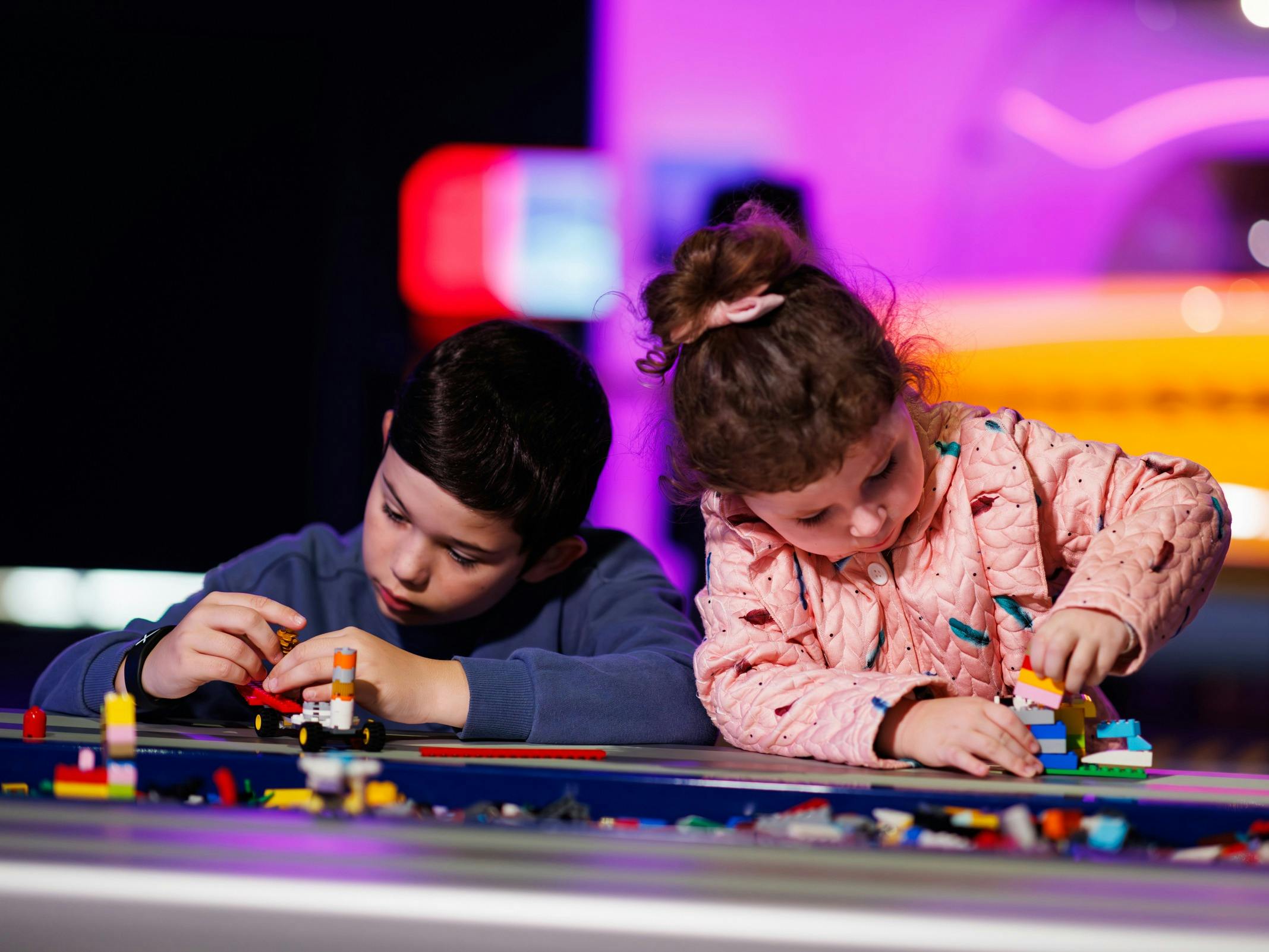 Two children play with lego