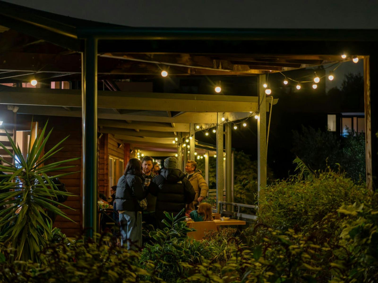 People gather under the lights at the Merri Cafe